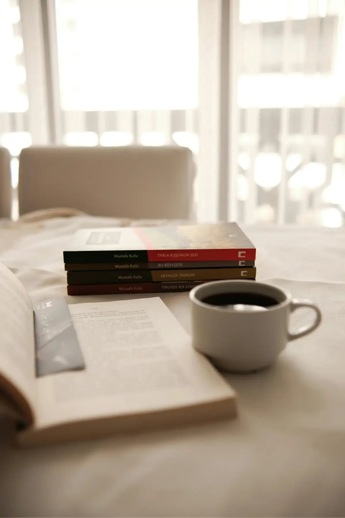 Stack of books and coffee on a table, representing study and inspiration for architecture students