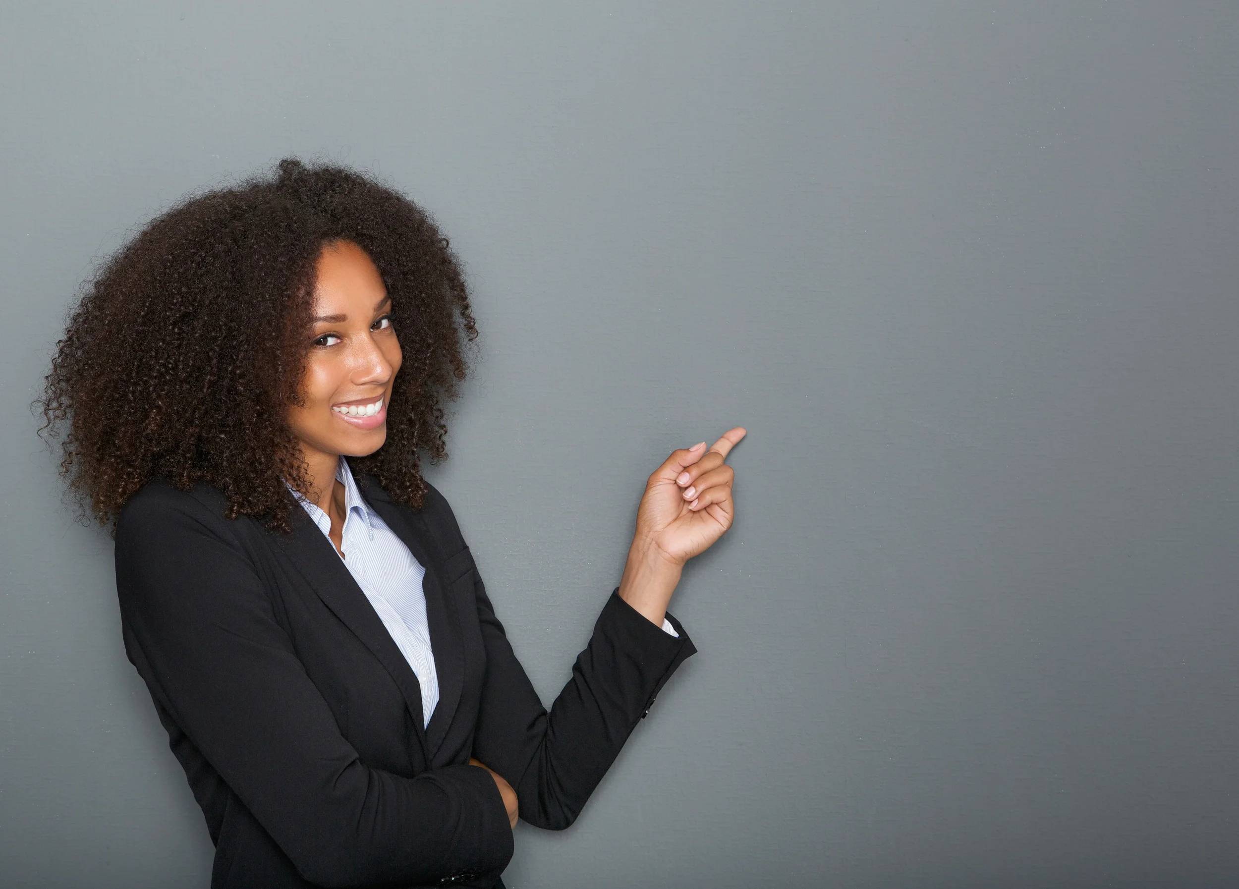 bigstock-Friendly-Business-Woman-Pointi-70007794.jpg