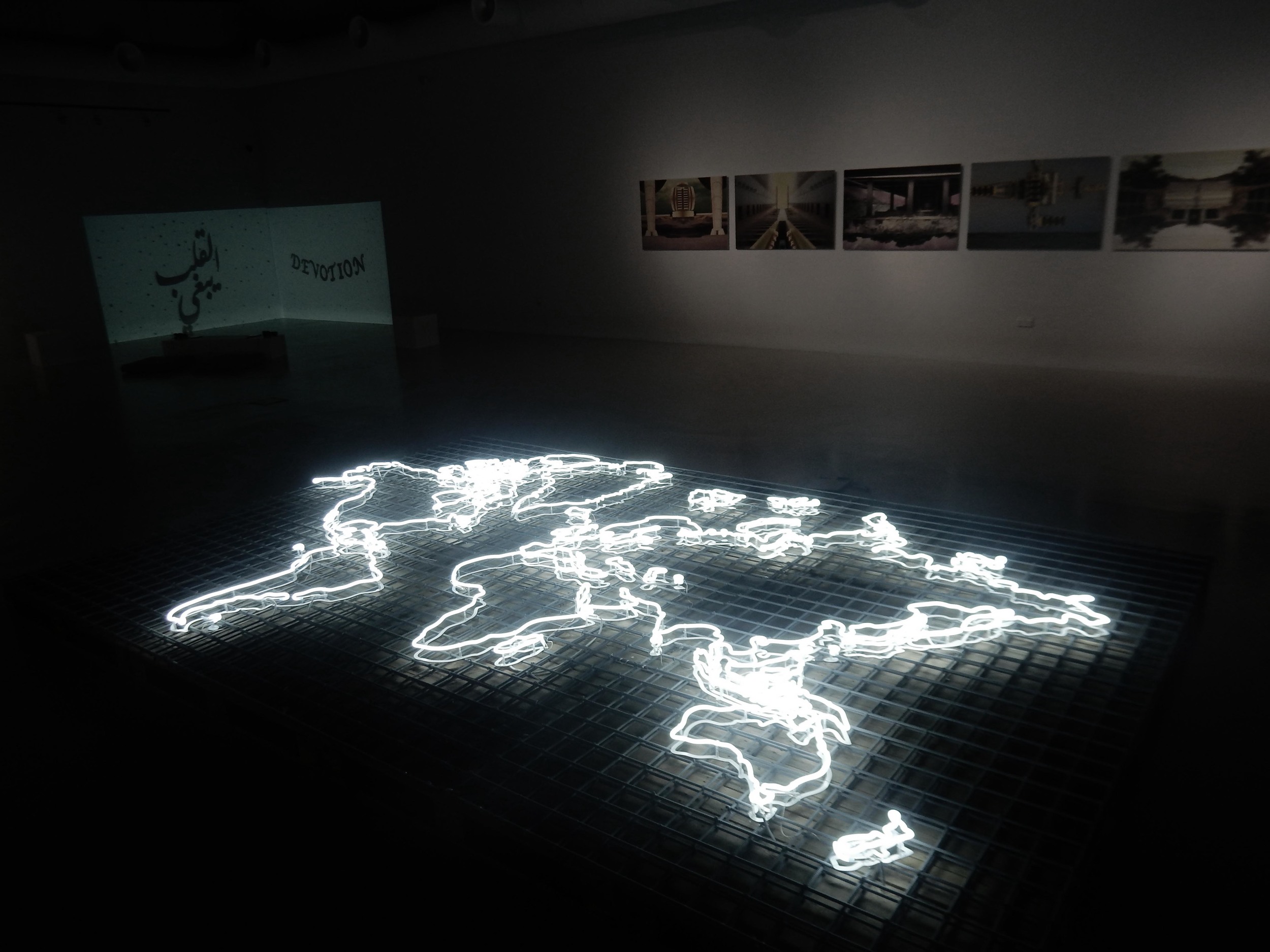 The grid made out of the welded metal mesh used in the foundation of the construction site serves on which latitude and longitude in this installation, and drawing the world map using neon tube lights. Latitude and Longitude play a major role in determining the time zones of different places throughout the world. In responding to the theme of (Haraka Baraka) humans are always on constant travel, from country to the other, from city to the next, from one location to another. Maybe we can’t always tell the where we are moving next, but we know it exist within the world map grid. Within the Grid is a reminder of where our families and friends live, places we had visited, and planning to visit. It is a chance to see how far we have reached and how close we are to our dreams, our movements are all within the Grid.
