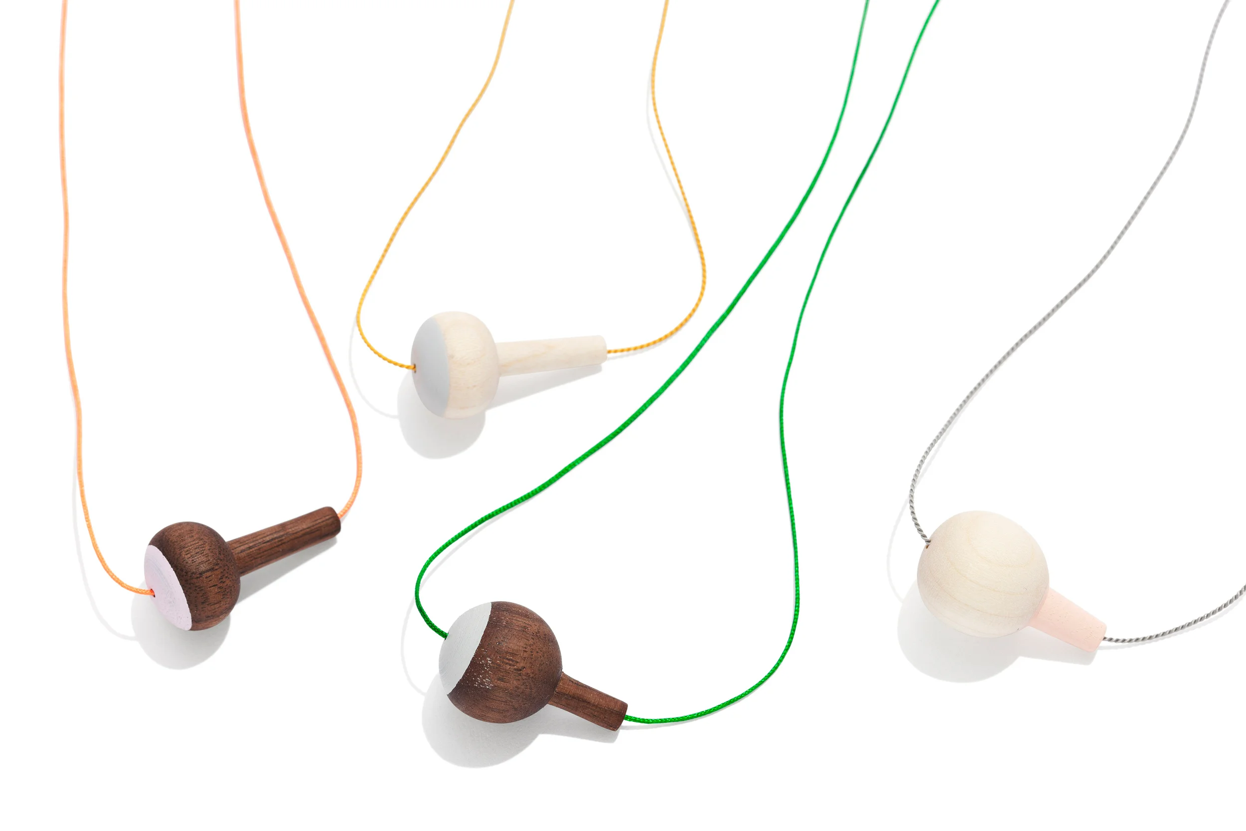Necklace Material: Maple/walnut wood, silk/nylon string, arcrylic paint, silver lock L: 30 Ø: 17 mm Design by Akiko Kuwahata Made by Akiko Kuwahata Participated in Crafts Collection 17 The inspiration for PUKA comes from the interesting forms and colours found in fishing tackle. The result is a necklace in turned wood, where the length of the string can be adjusted by pulling the silver ball that adorns the chain.
