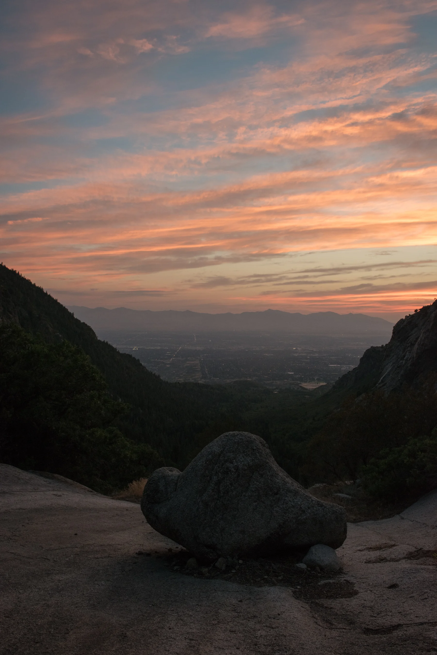 From Bells Canyon looking west towards the Oquirrh Mountains wildfire haze filters the remaining light of the day. Bells Canyon was shaped by glaciers which melted and help create Lake Bonneville, a now gone enormous ice-age lake. Lone Peak Wilderness, Wasatch Front, Utah.