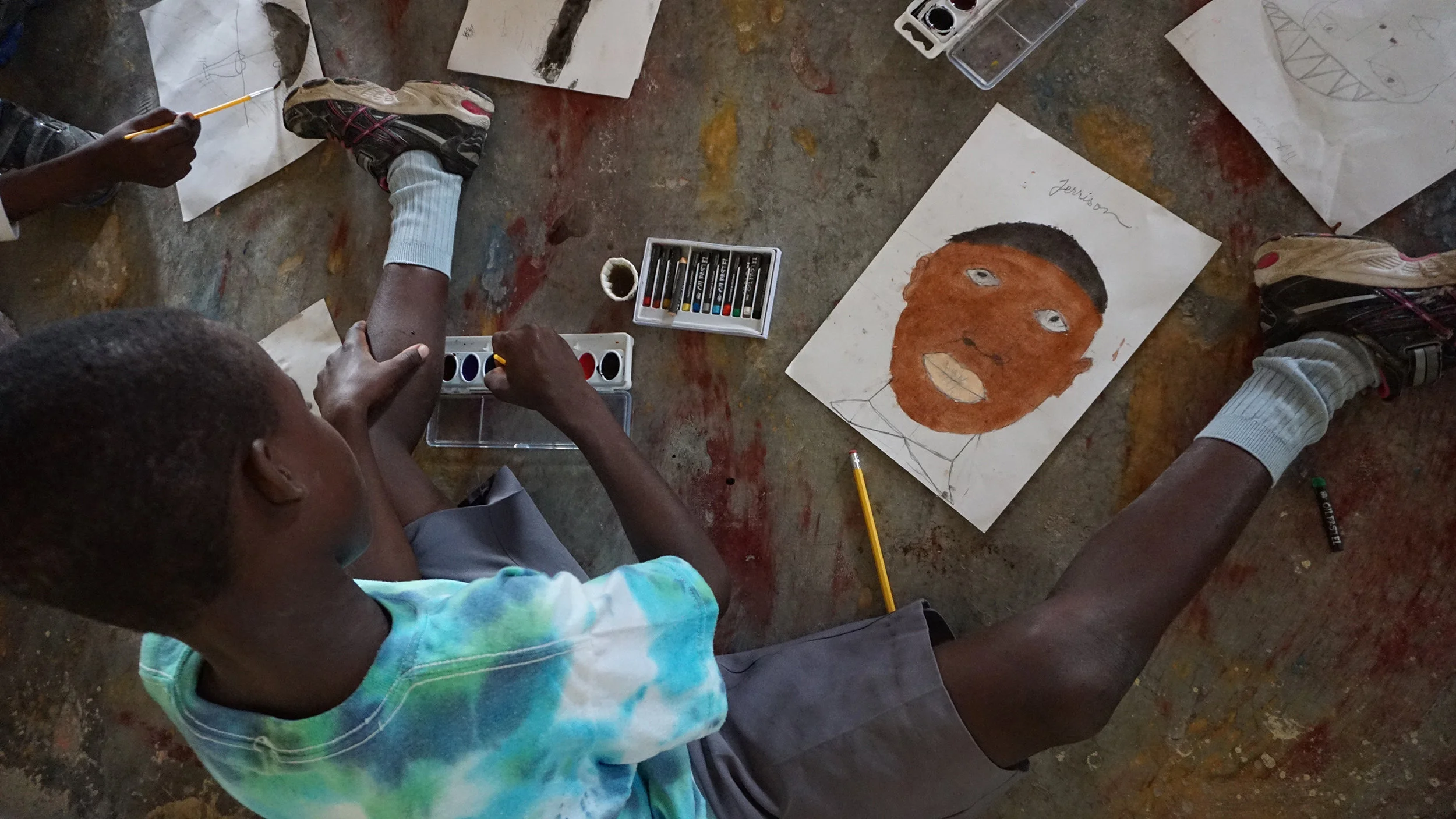 Hague Williams teaching art to children.