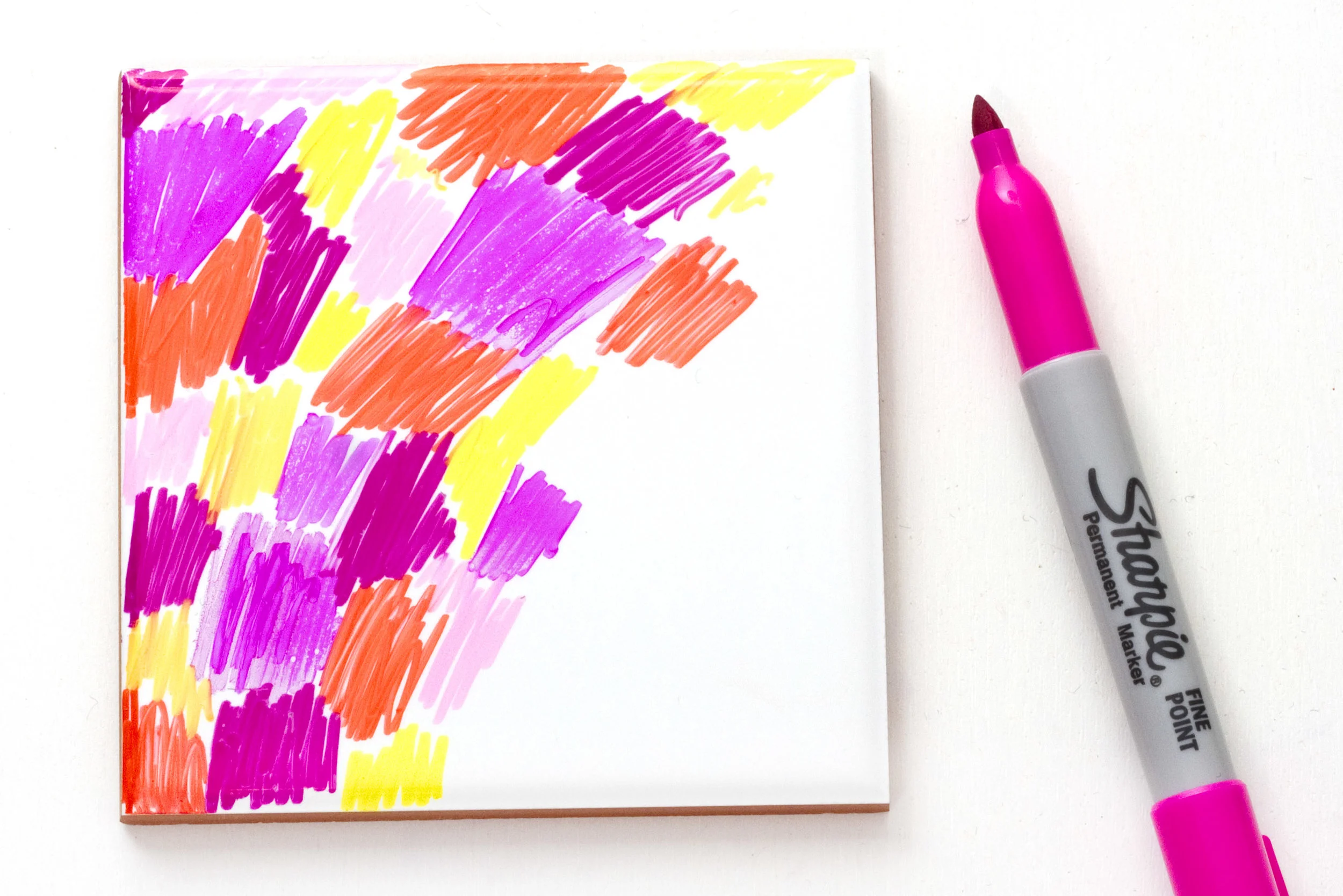 Step 1. Pick the colours you want for your coaster. For this tutorial I have chosen pinks, yellows and oranges for a summery look. Then begin to colour in the tile, making sure you cover the whole of the top surface.