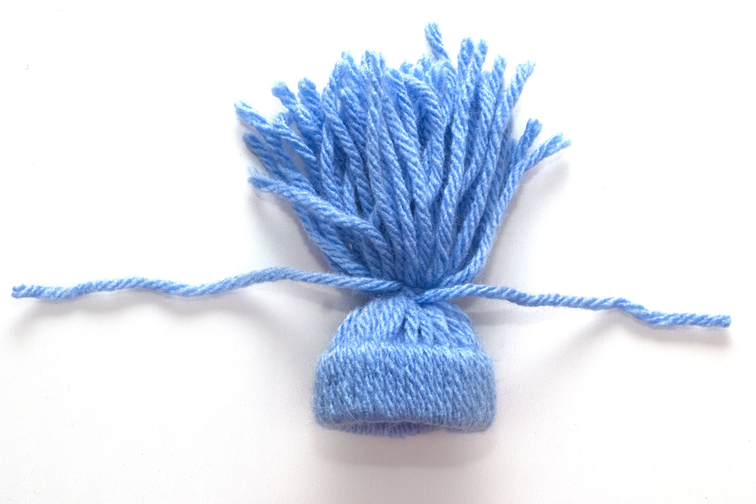 Step 3 Using one piece of wool, tie up all of the ends of the wool you have attached to the toilet roll. Tie the knot into a tight double knot. Finally, trim the ends of the wool until you get a lovely shaped pom pom on the top. Place on your egg and you're done! Subscribe to my newsletter to receive fun craft ideas weekly! Please note: this blog post contains affiliate links, however all opinions are my own and I only link to products that I personally use and recommend.