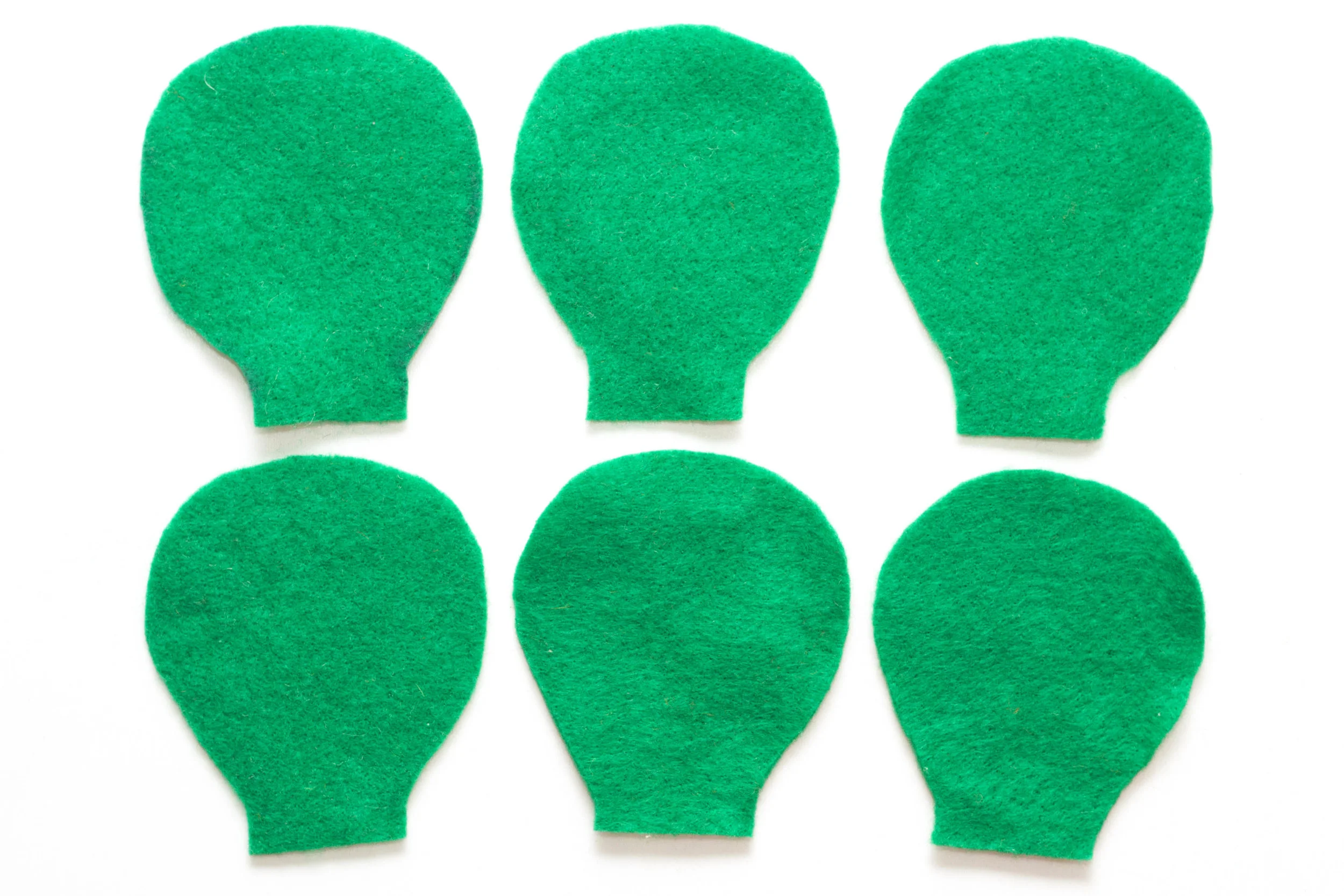 Step 1 Draw the shape seen in the photo above onto the green felt six times and cut these shapes out (the shape should be approximately 10cm high). These will form the cactus. It helps to make a template first so all of the shapes are identical.