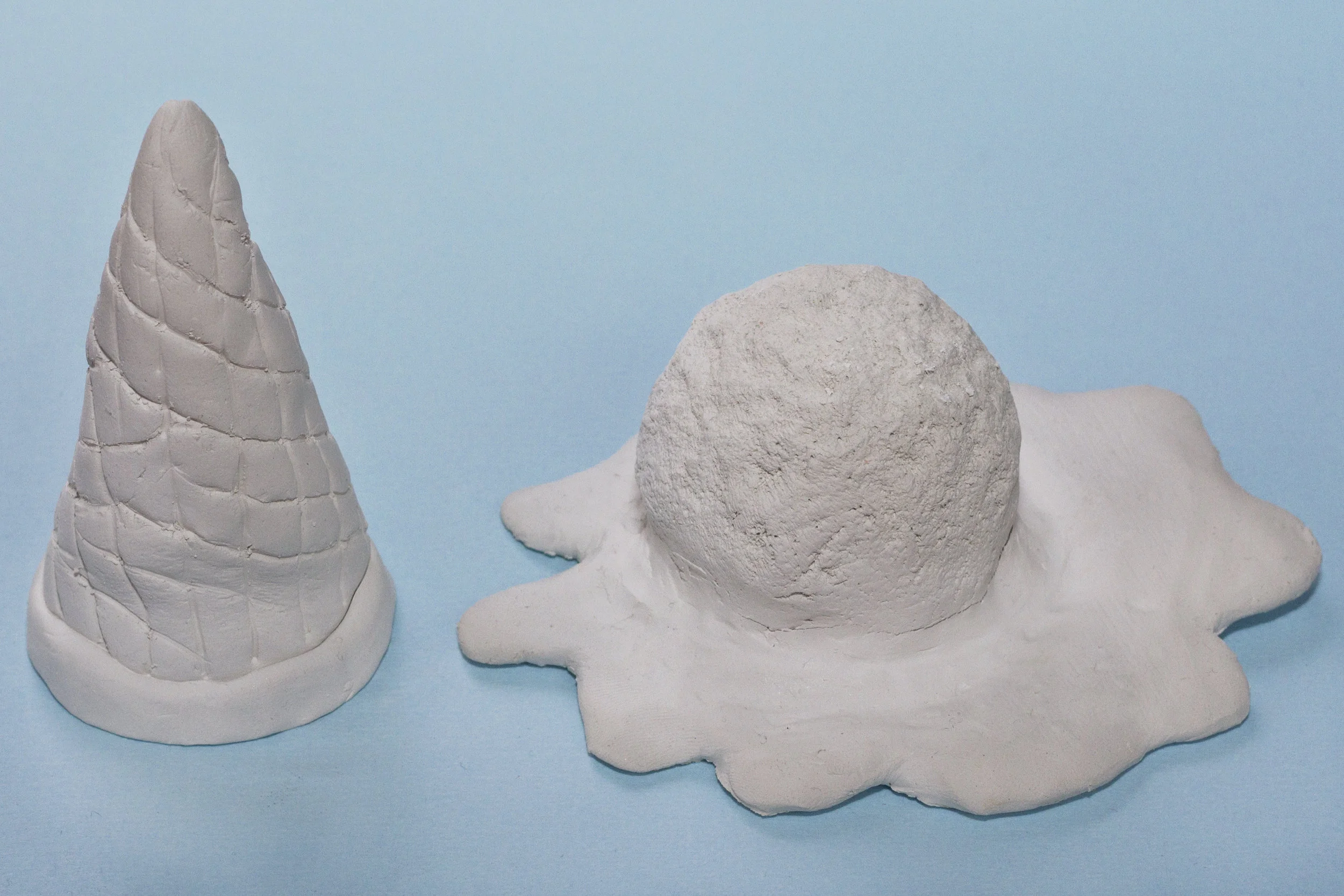 Step 2 Using another piece of clay, roll it flat (about 5mm deep) and then use a cutting tool to cut out a splatted shape. Push the ball of clay that you made onto this shape and smooth the edges so it becomes one piece. Roll a cone shape out of another bit of clay and use the cutting tool to make the markings shown in the above image. Leave the clay to dry overnight.