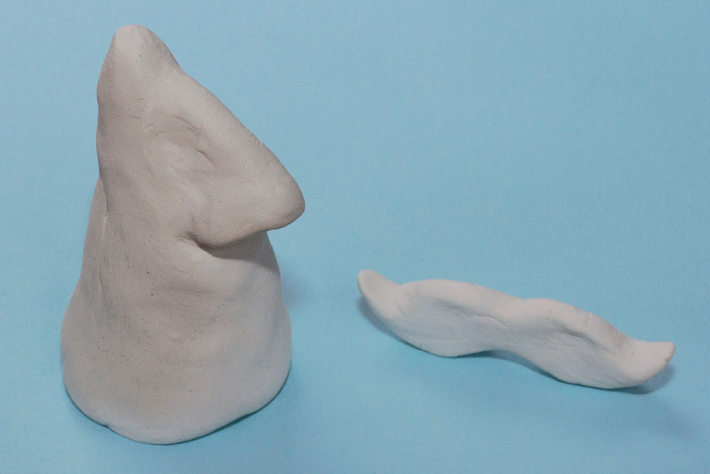 Step 1 Take a large section of the air dry clay and make a cone shape. Then mould a smaller nose shape and attach the two together, smoothing the edges so that it doesn't come apart. Take another smaller piece of clay and mould a moustache shape. Leave all the pieces to dry overnight.