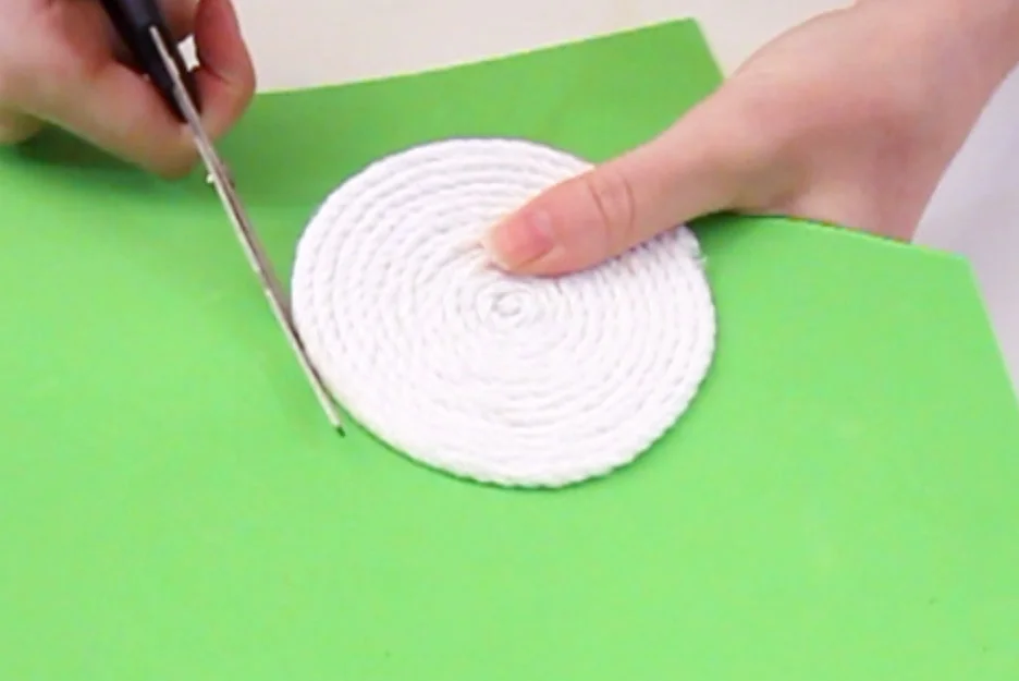 Step 2 Once you are happy with the size of the coaster, ensure the end of the rope is glued to the foam and then cut around the shape.