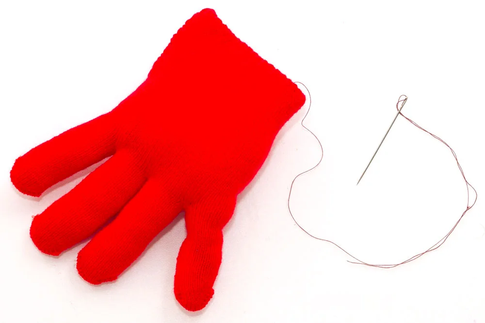 Step 2 Stuff the glove! Make sure you push the stuffing into the glove fingers first otherwise they will be hard to get to at the end. Then stitch up the openings (an adult might have to do this bit if the child is too young).