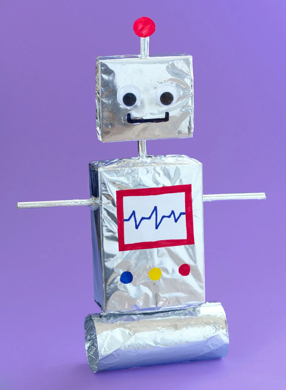 Step 3 Push one straw through the two side holes in the big box to make the robot's arms. Then push the other straw into the hole on the top of the box, and put the top of that straw into the hole in the smaller box to attach the robot's head. Glue all of the pieces together. Then, on some white paper, draw some buttons and a screen to put on the body of the robot.