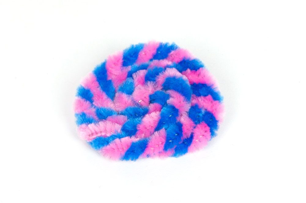 Step 2: Once the pipe cleaners are fully twisted together, wrap them around to form a spiral - this will be the lolly pop!