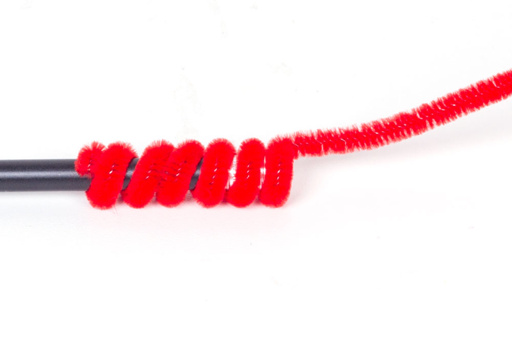 Step 1 Wrap the end of a pipe cleaner round the pencil to create a spiral. This will need to be quite tight as it is what will hold your craft to the top of the pencil. Leave about an inch at the end of the pipe cleaner straight - this will be to stick the ladybird to it.