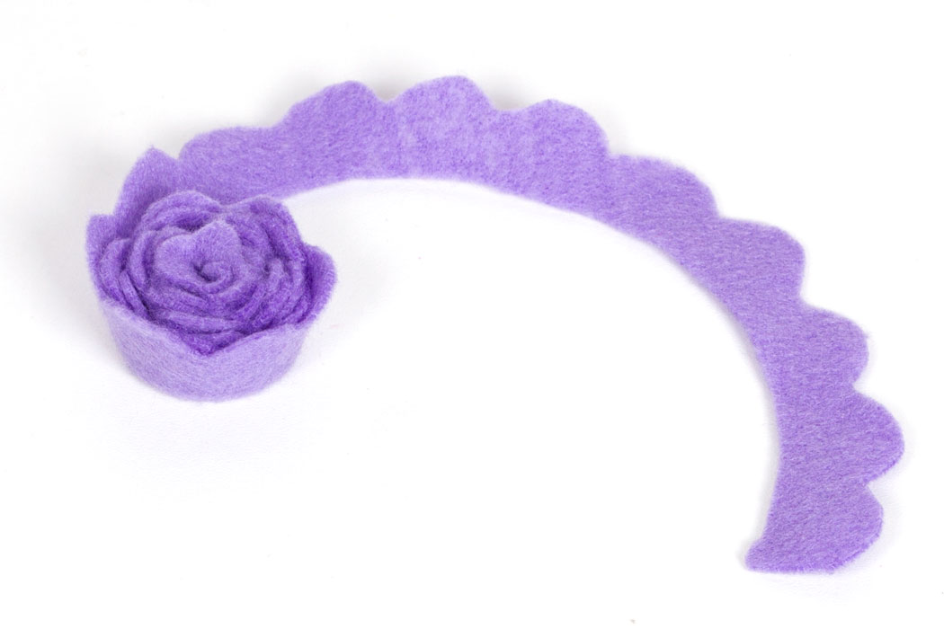 Step 3 Roll up the felt, starting from the centre and working outwards. You should begin to see the shape of a flower forming in the felt. Once you have rolled the felt up, hold in place and glue the end down with the glue gun. Turn the flower upside down and glue the bottom of the felt to hold it in place. Finally, cut a small strip from the magnetic tape and stick to the bottom of the felt flower. Subscribe to my newsletter to receive fun craft ideas and freebies!