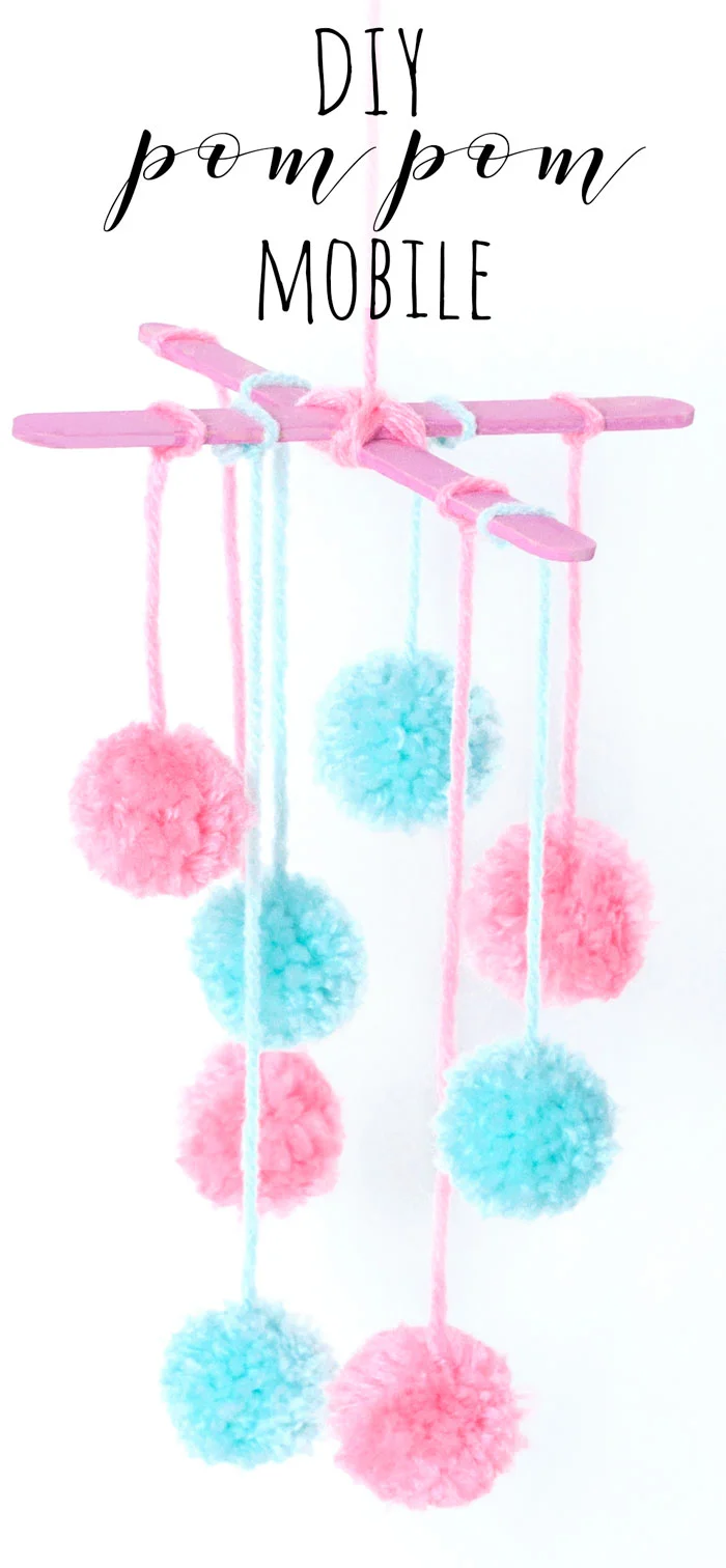 Make a pretty mini pom pom mobile out of wool and lolly sticks. This craft would look lovely hanging in the nursery/baby's room, or create it with colourful wool to make some funky home decor!