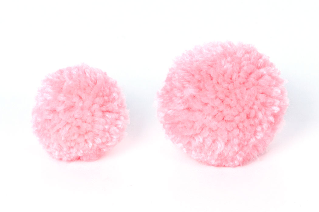 Step 1 Follow this tutorial to learn how to make two pom poms. For the bunny use light pink wool, and for the chick use yellow. Make one pom pom bigger than the other by changing the size of the card ring.
