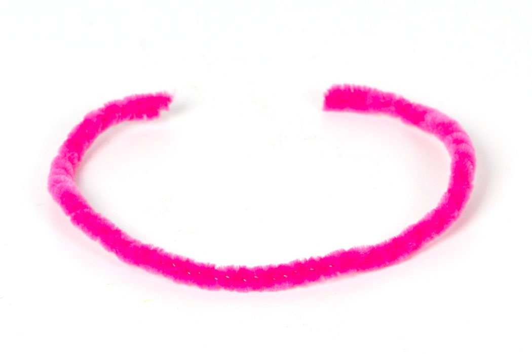 Step 1 Take two pink pipe cleaners and twist together to make one thicker and stronger pipe cleaner. Then bend it into a horseshoe shape to form the headband of your tiara.