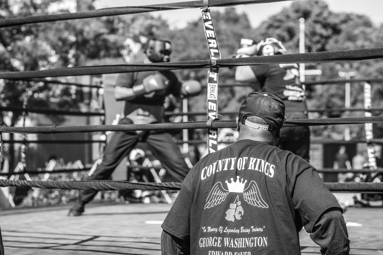 "We all family here", says Nate Boyd. Peoples' reasons for boxing vary widely. An important aspect that keeps people coming back is the camaraderie, welcoming atmosphere and discipline boxing gives its practitioners. Nate looks on at two young fighters at an outdoor boxing ring in Brooklyn. The event was an opportunity for the Nate to show the community the benefits of boxing and sport in general.