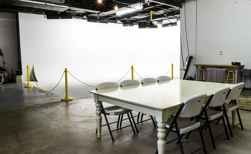 The stage with tables and chairs set up in front of the cyc