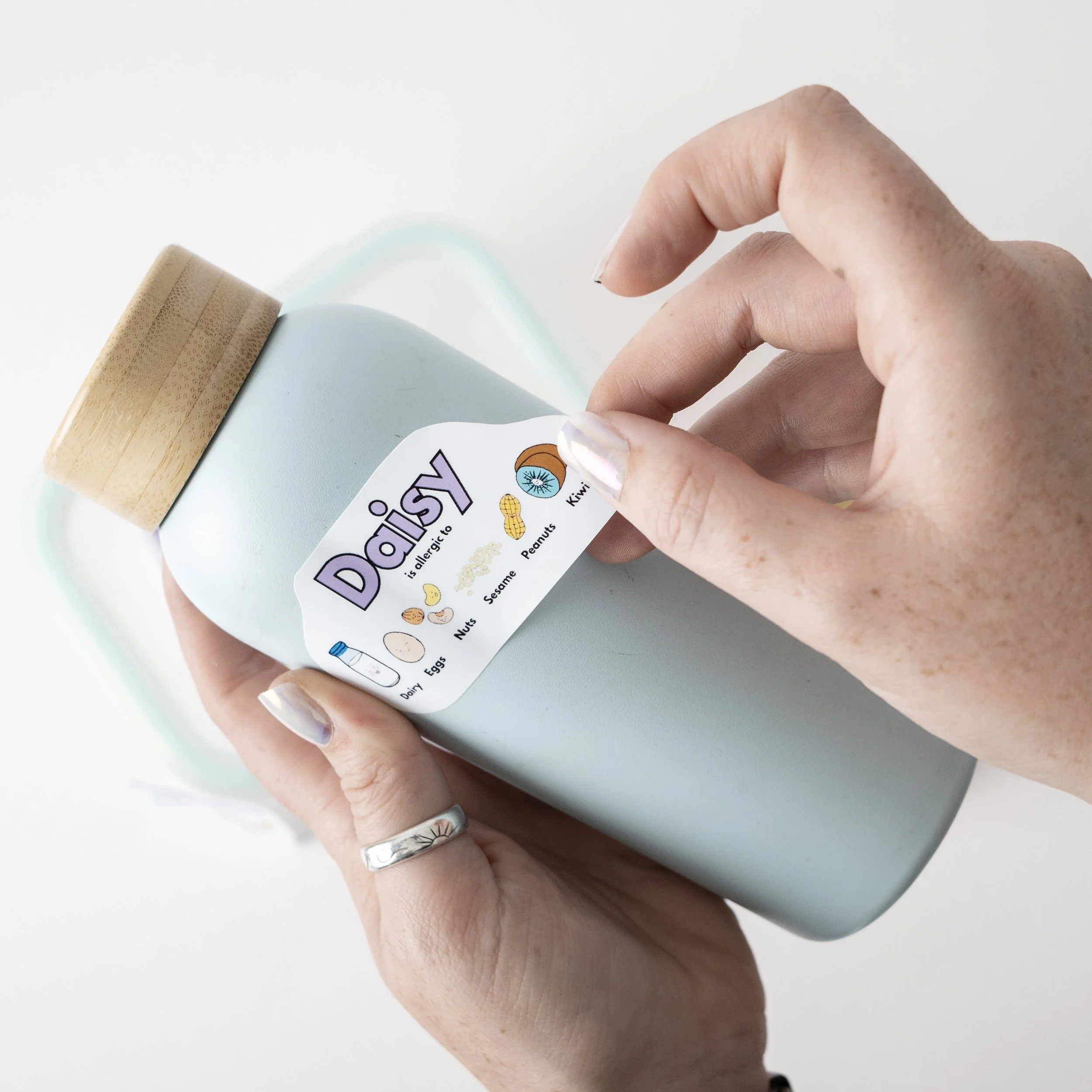 Stickers being placed on a water bottle