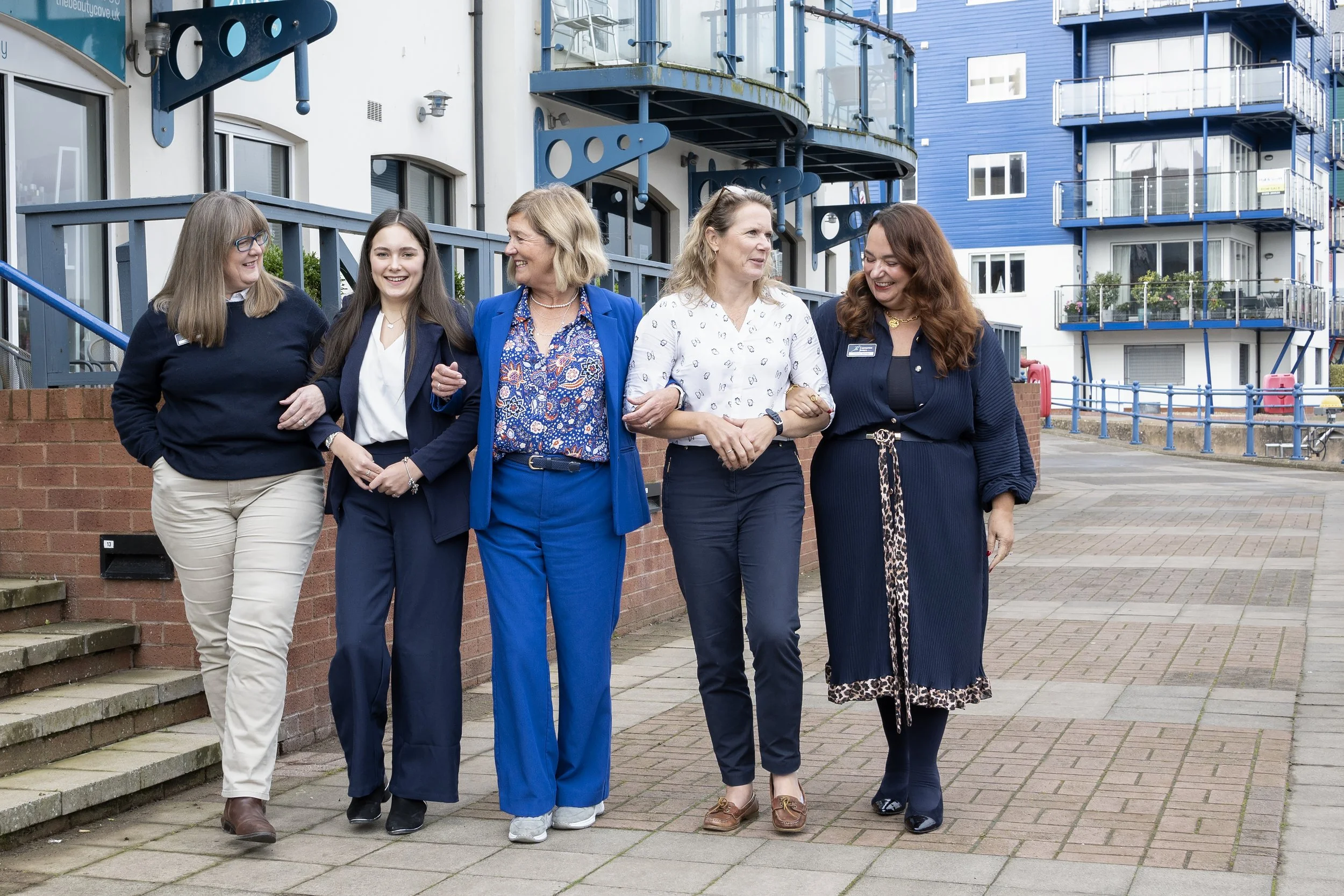 ladies walking arm in arm along the quayside
