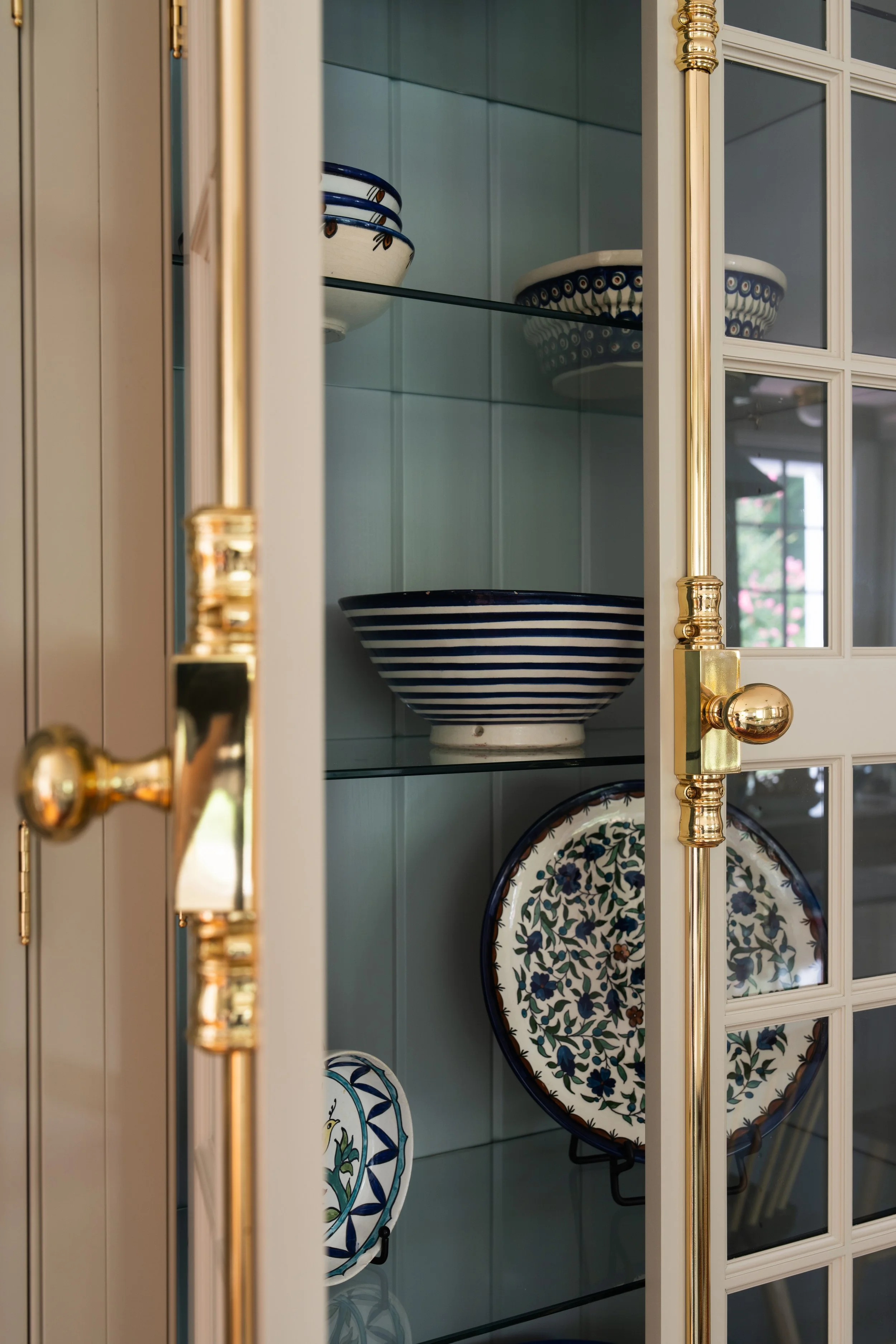 Close-up of open display cabinet with bowls and plates.