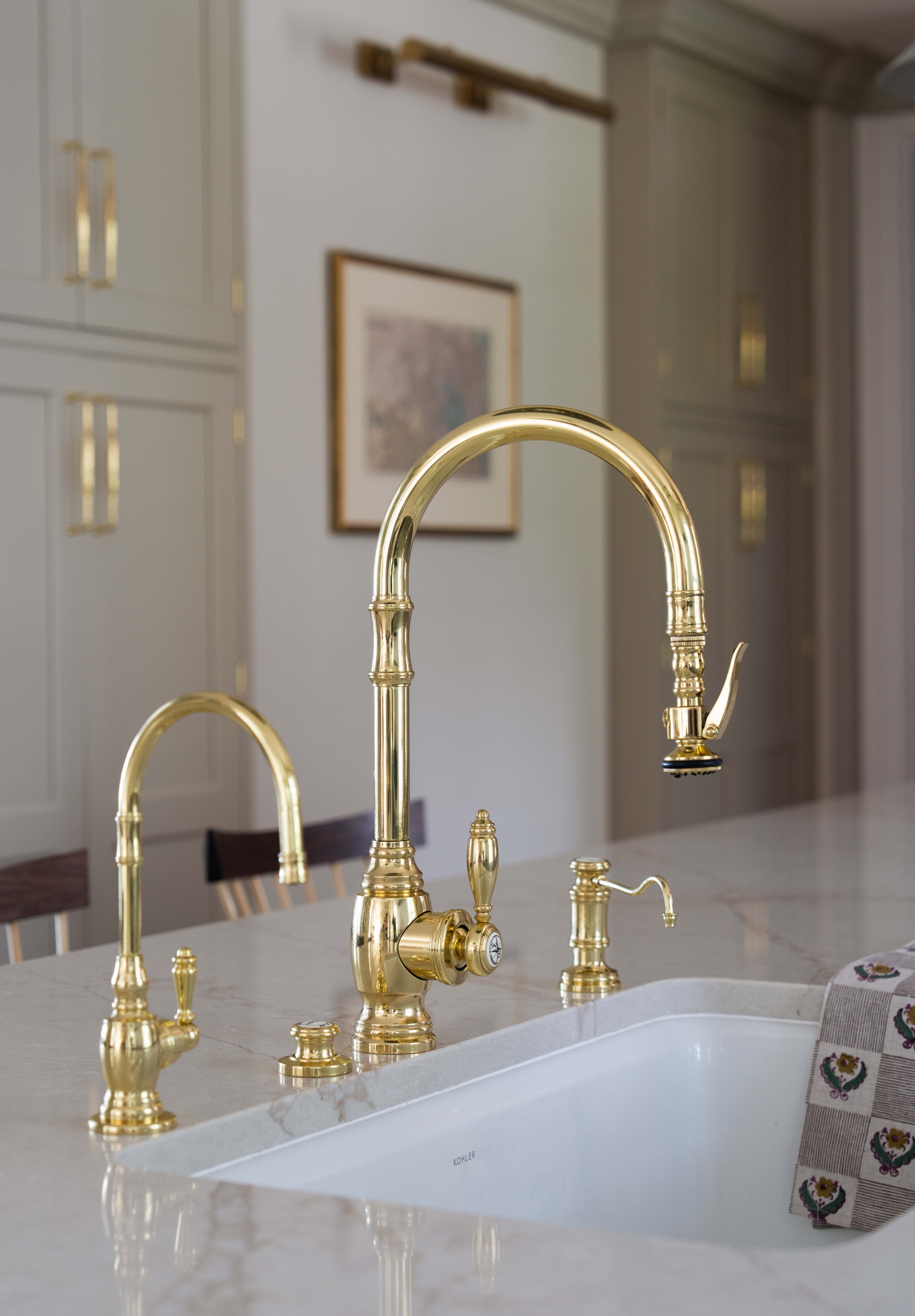 Close-up of brass kitchen faucet.
