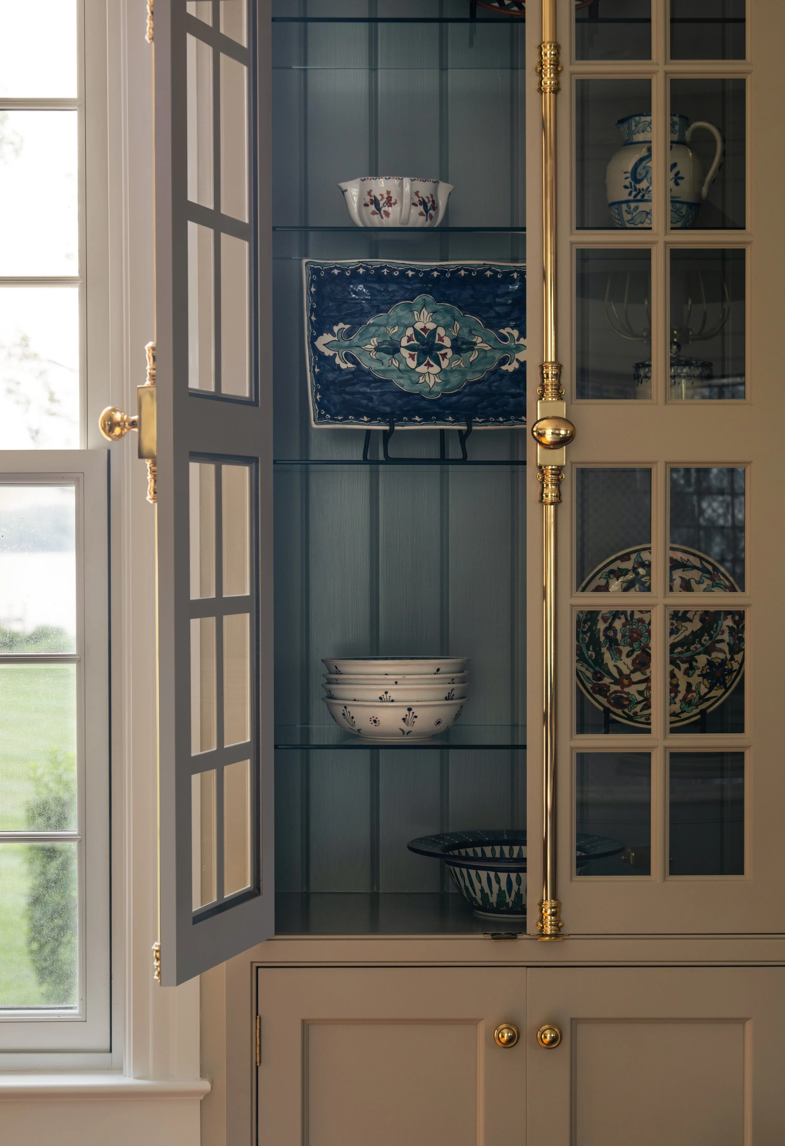 Opened display cabinet with bowls and dishes.