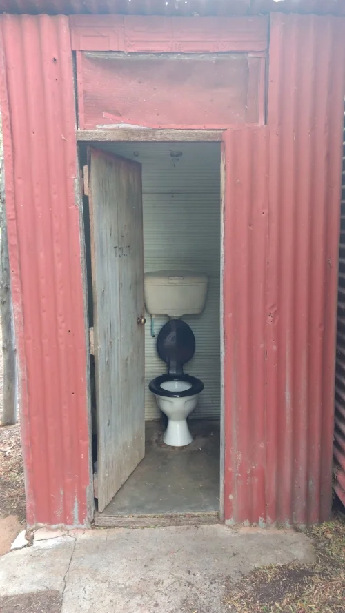 Hanging Cistern Toilet in the Outhouse. Image Source - Loop Interiors