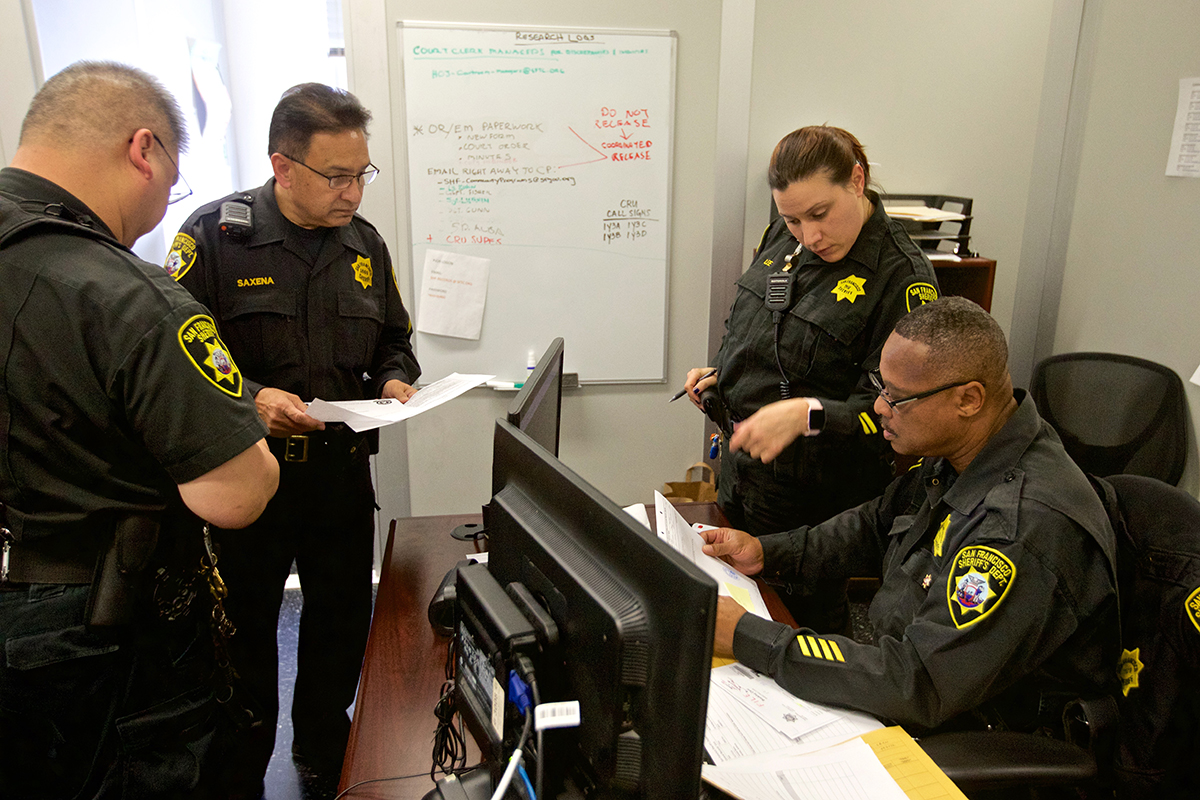 San Francisco lacks a fully interconnected criminal justice computer database that shares information in real time. Sheriff’s deputies must still review paper instructions from the court. Photo by Kevin Hume.