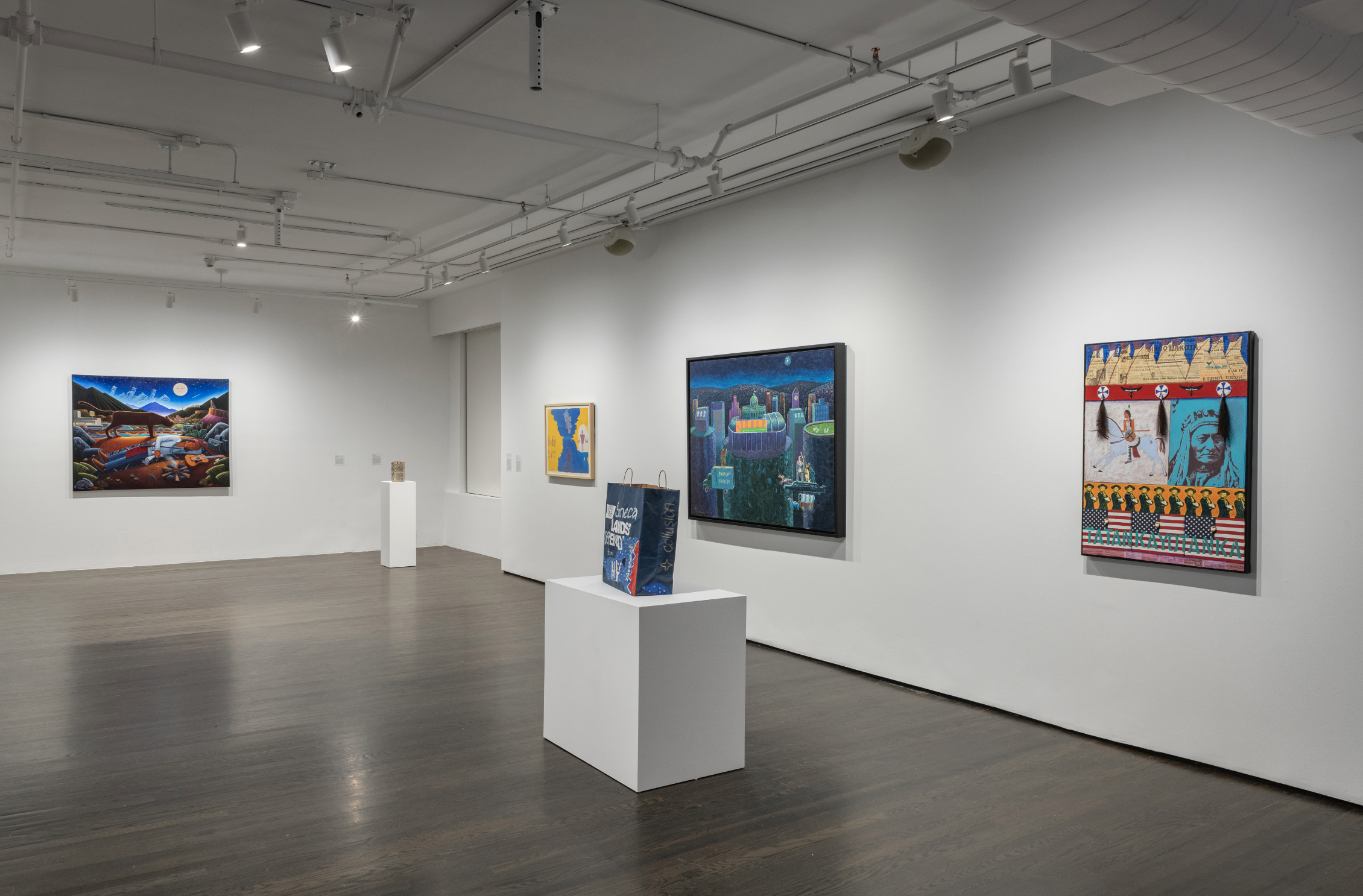  Installation view of  The House Edge  at The 8th Floor, September 2023. Featuring (left to right) David Bradley,  Sleeping Indian, Shiprock/Santa Fe , 2008; Joe Feddersen,  Bingo , 2017; G. Peter Jemison,  Choices—Great Law or Gambling? , 1998 and 2