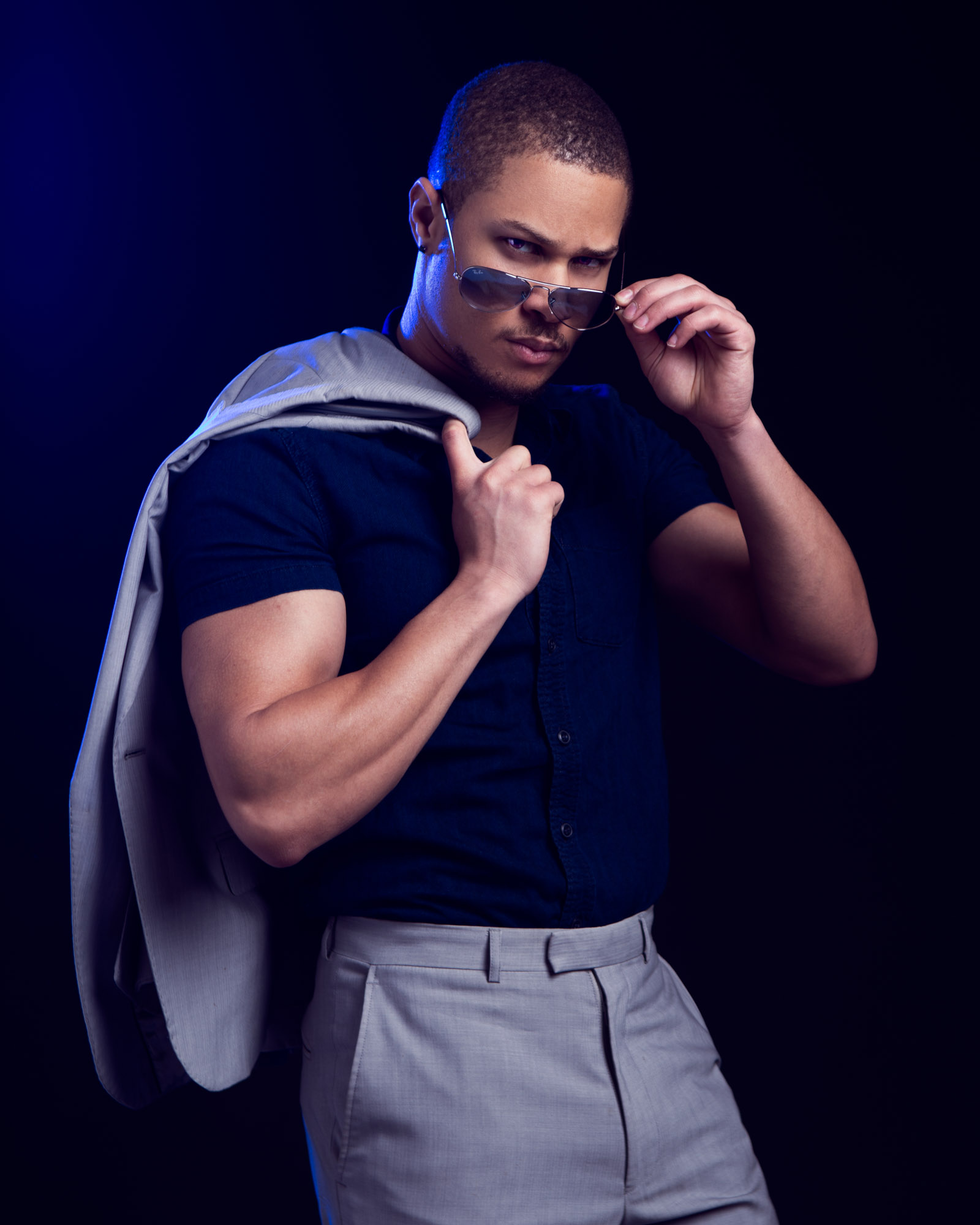 man with coat over shoulder studio fashion photography