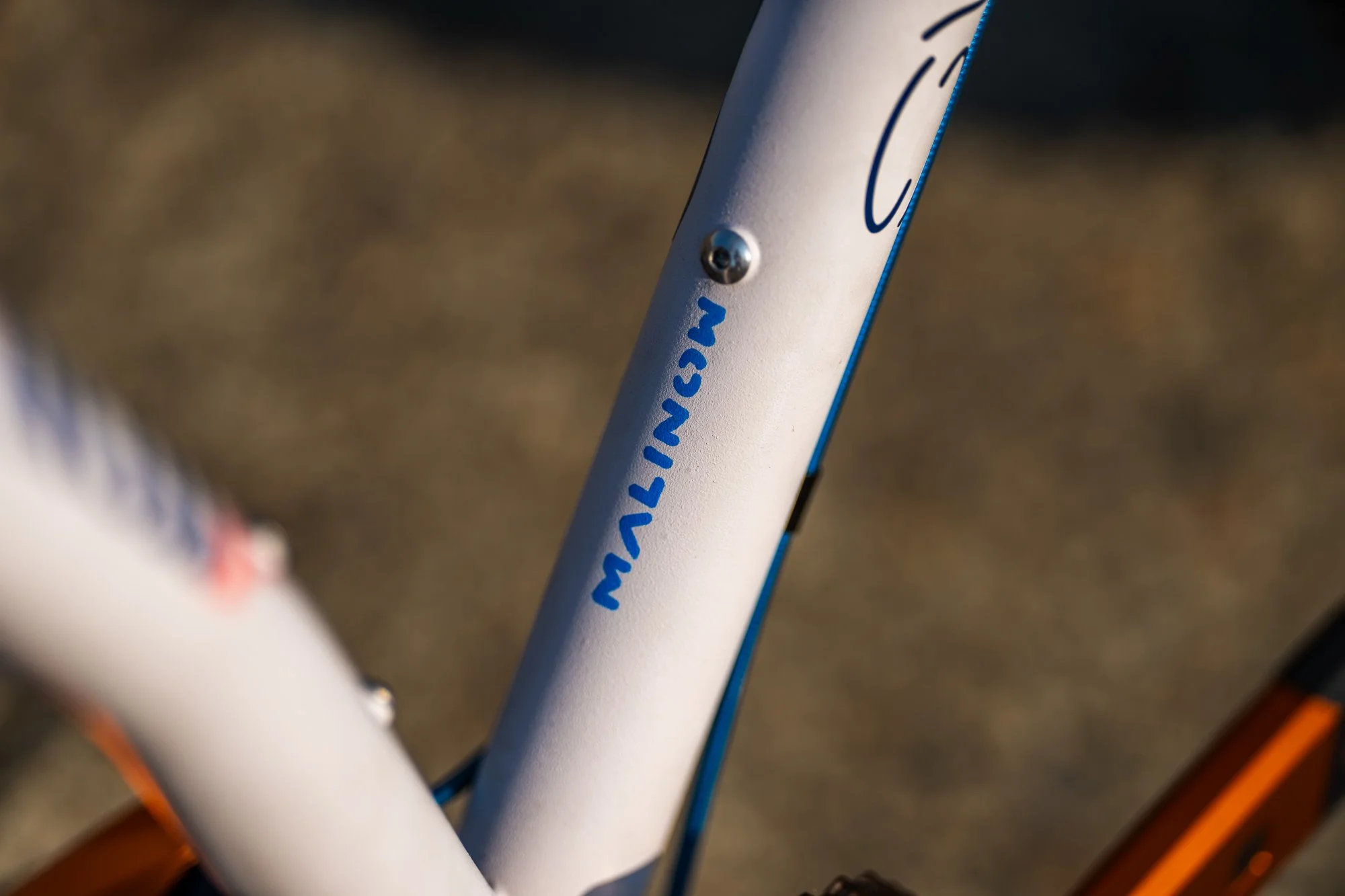 Hand-painted Singular Swift rigid mountain bike featuring custom calligraphic enamel artwork by Chet Malinow, showcased at the MADE Bike Show in Portland Oregon.