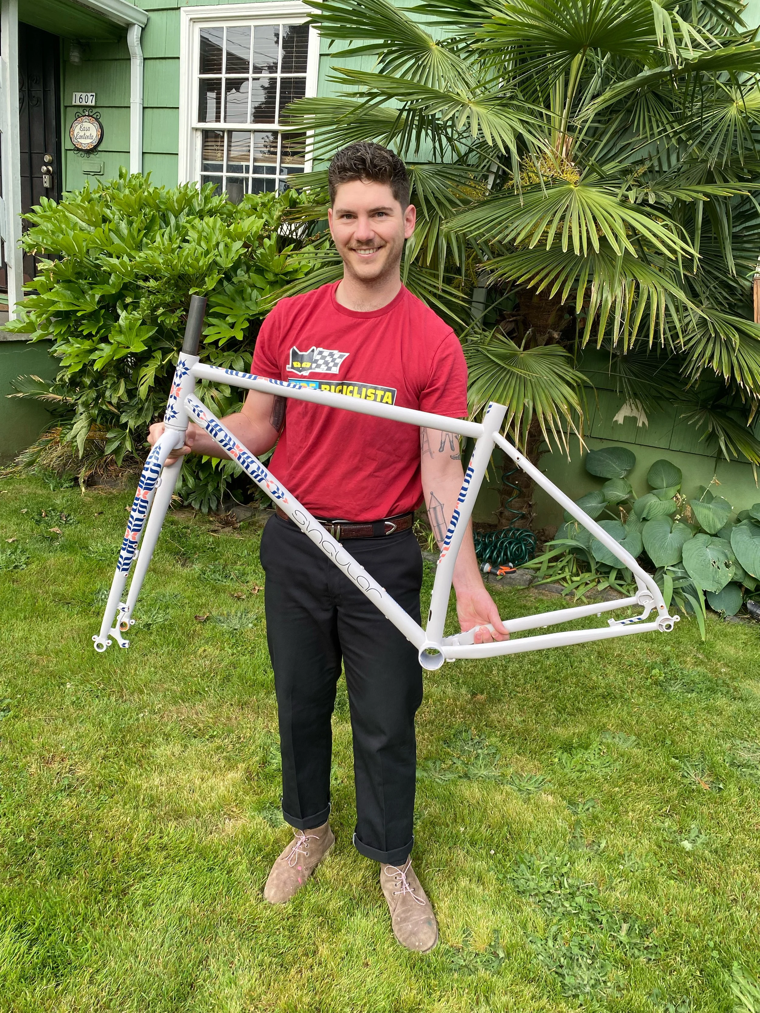Custom Singular Swift rigid mountain bike with hand-painted calligraphic enamel detailing by artist Chet Malinow, photographed at the MADE Bike Show in Portland, Oregon.