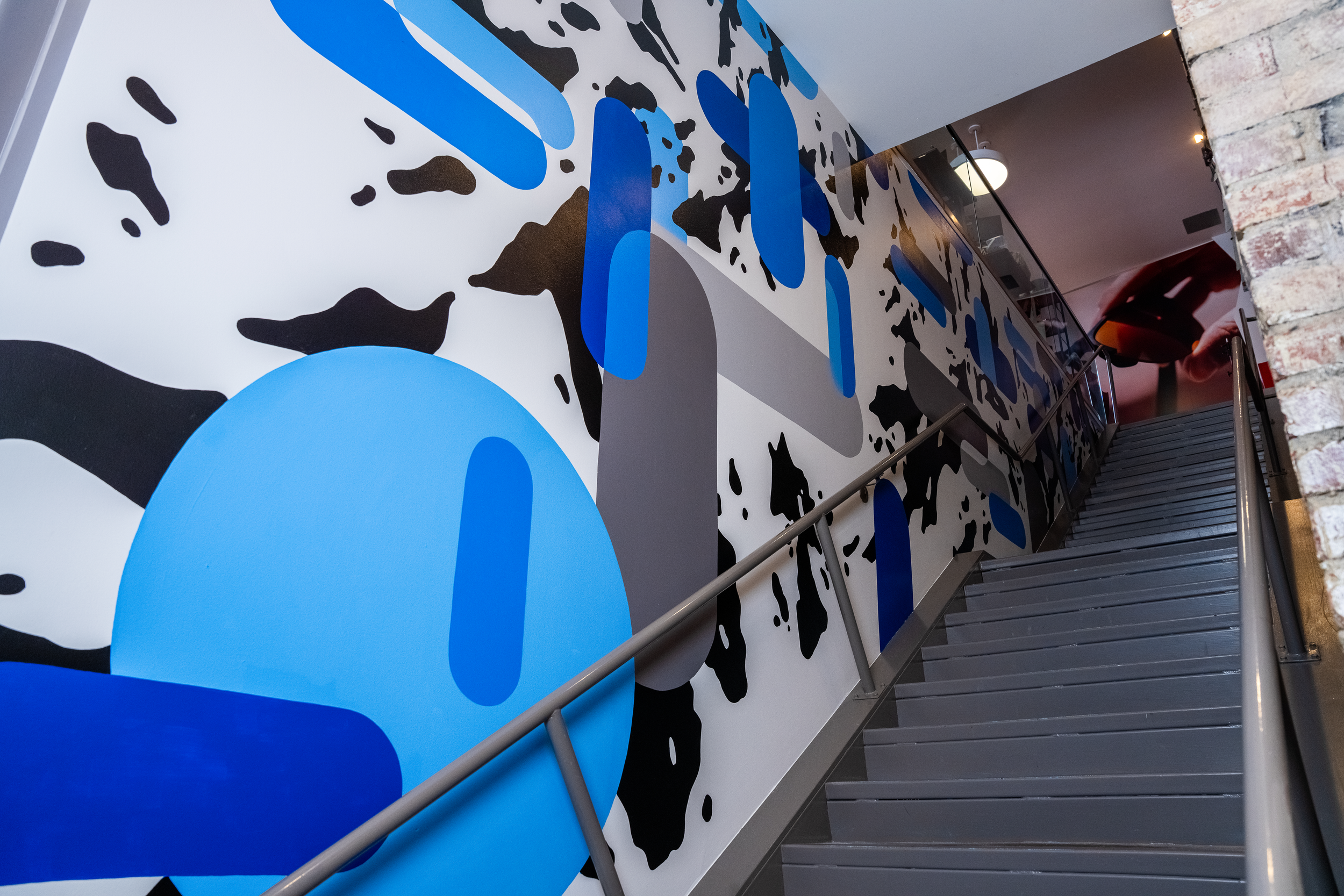 Revant Optics staircase mural located at Revant Optics HQ. Designed and painted by Chet malinow.