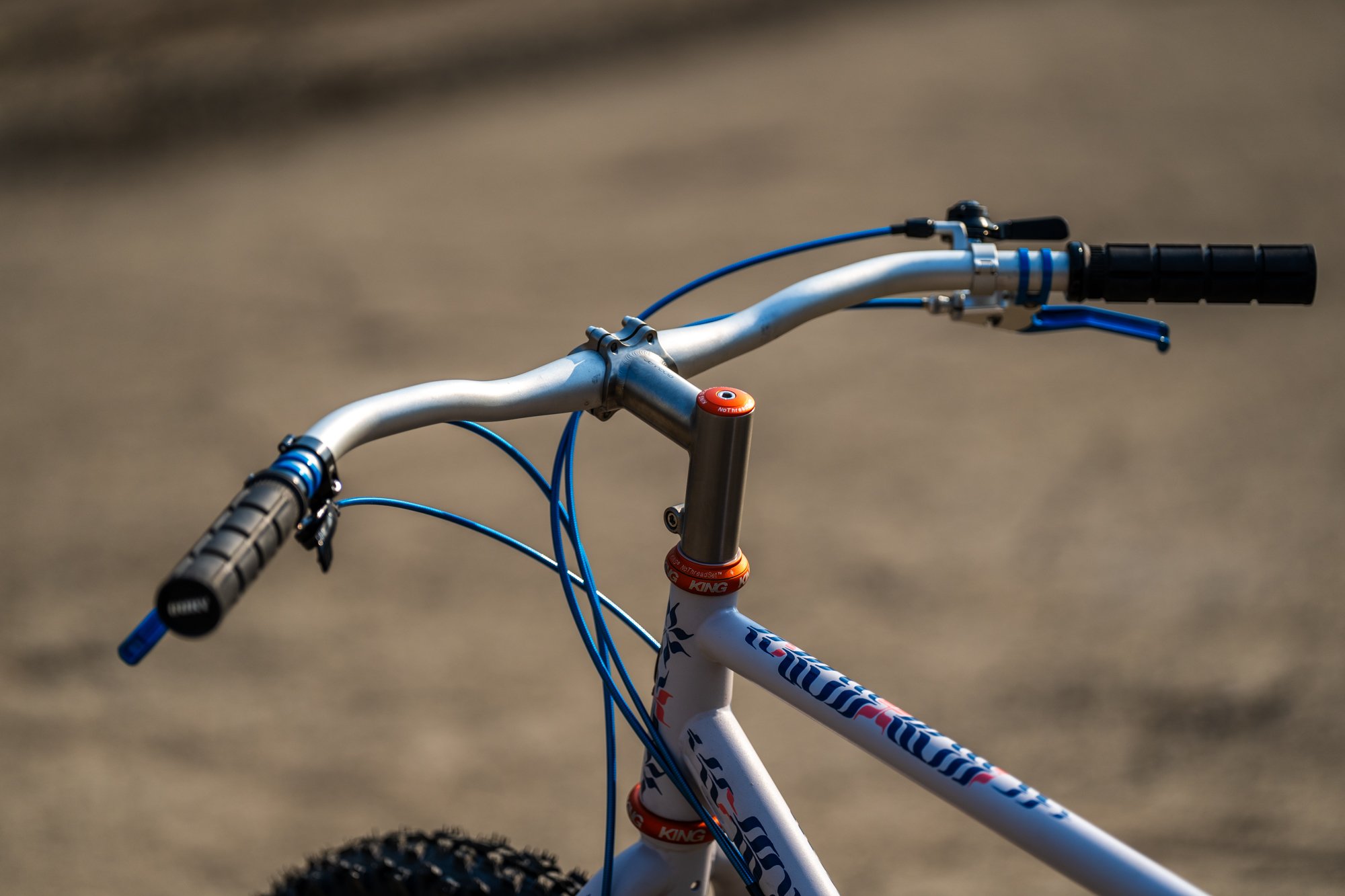 Hand-painted Singular Swift rigid mountain bike featuring custom calligraphic enamel artwork by Chet Malinow, showcased at the MADE Bike Show in Portland Oregon.