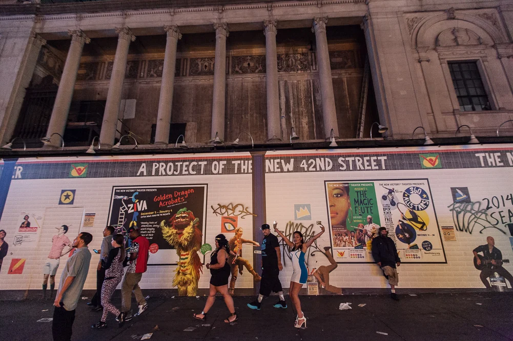 Party goers still awake after exiting a bar at 4:40am in Time Square.