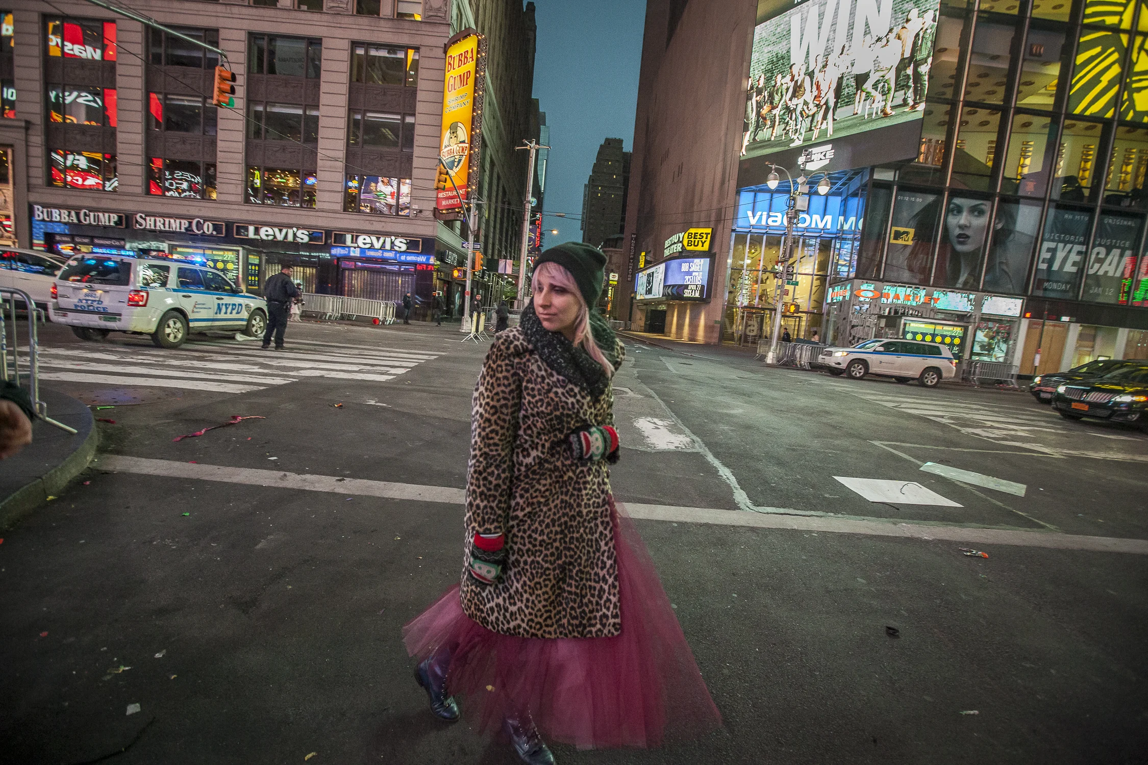 A women walking by herself at 6am following the NYE ball drop in NYC 