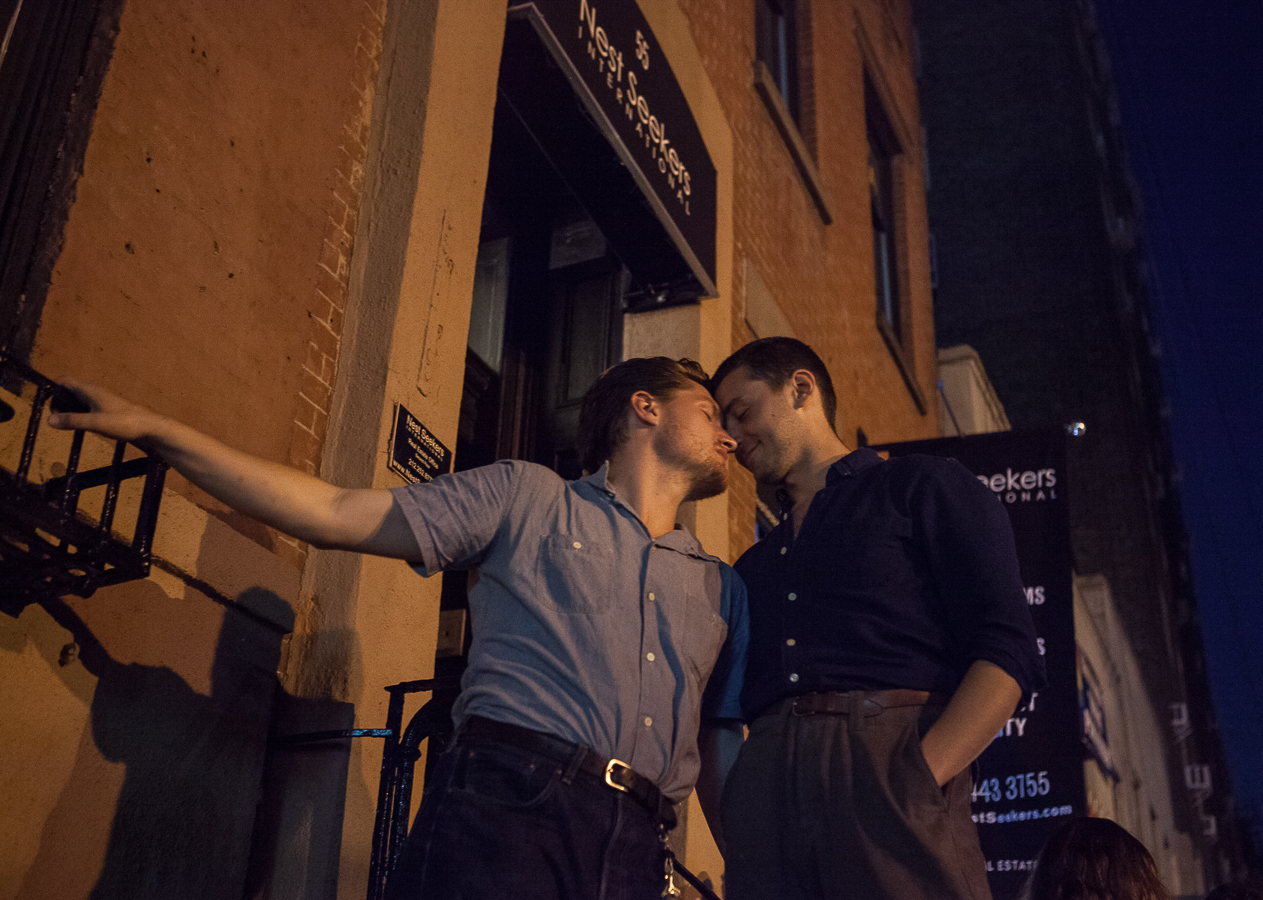 A couple on a fire escape outside of Stonewall Inn, birthplace of the Gay Rights Movement, during Drag March in New York City June 23, 2016.