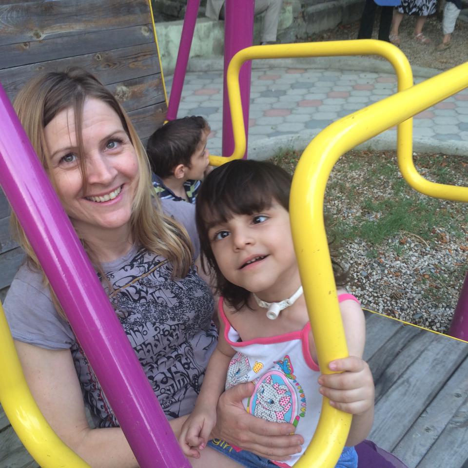 Jody Santos on a swing with a girl living in an orphanage in the Republic of Georgia