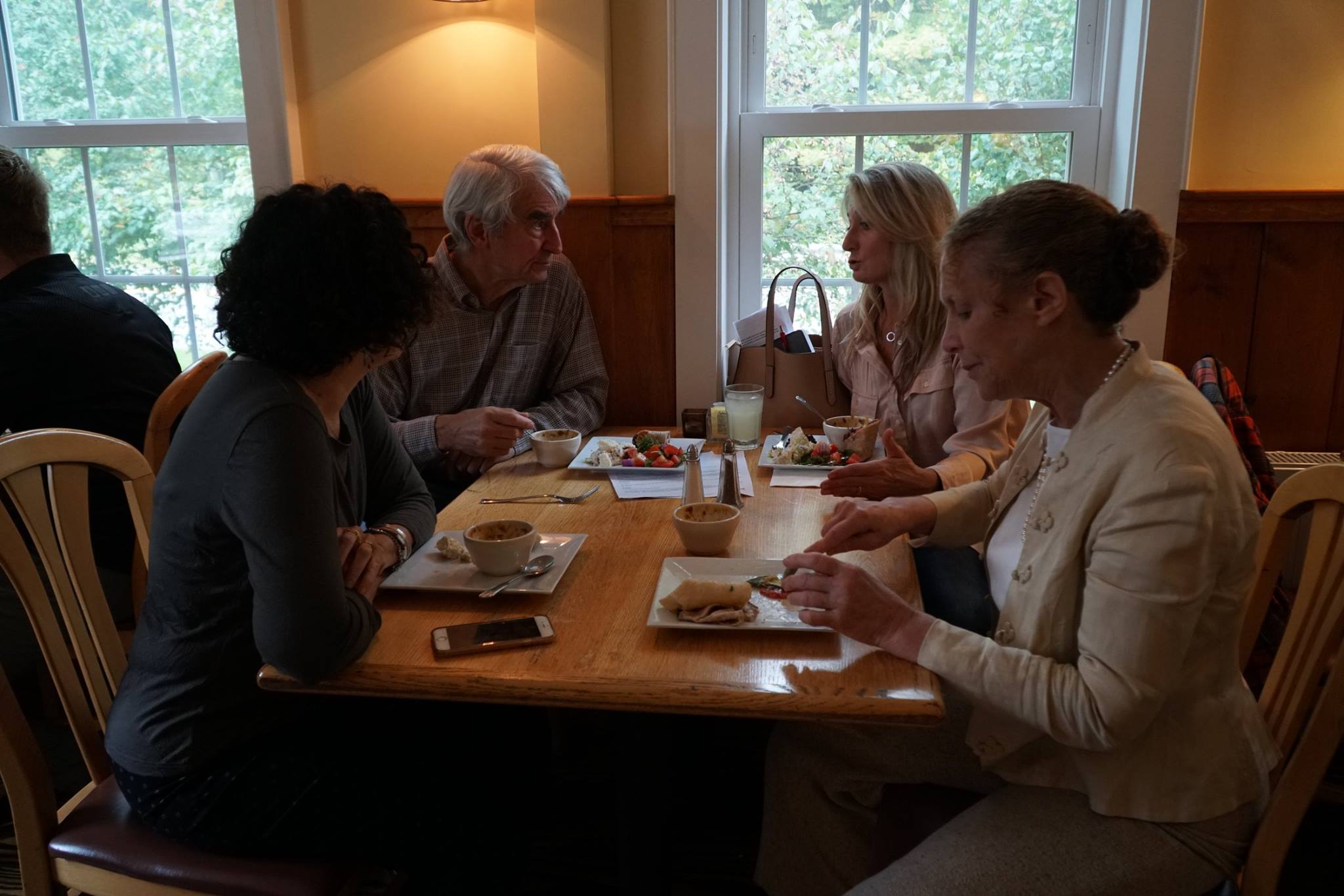  People gathered around a table eating lunch with Sam 