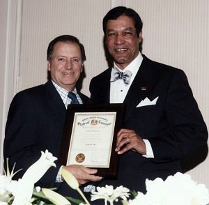 Leonard Kleinpeter, representing Governor Kathleen Babineaux-Blanco's office presents Rhaoul A. Guillaume, Sr. with the proclamation from the State of Louisiana