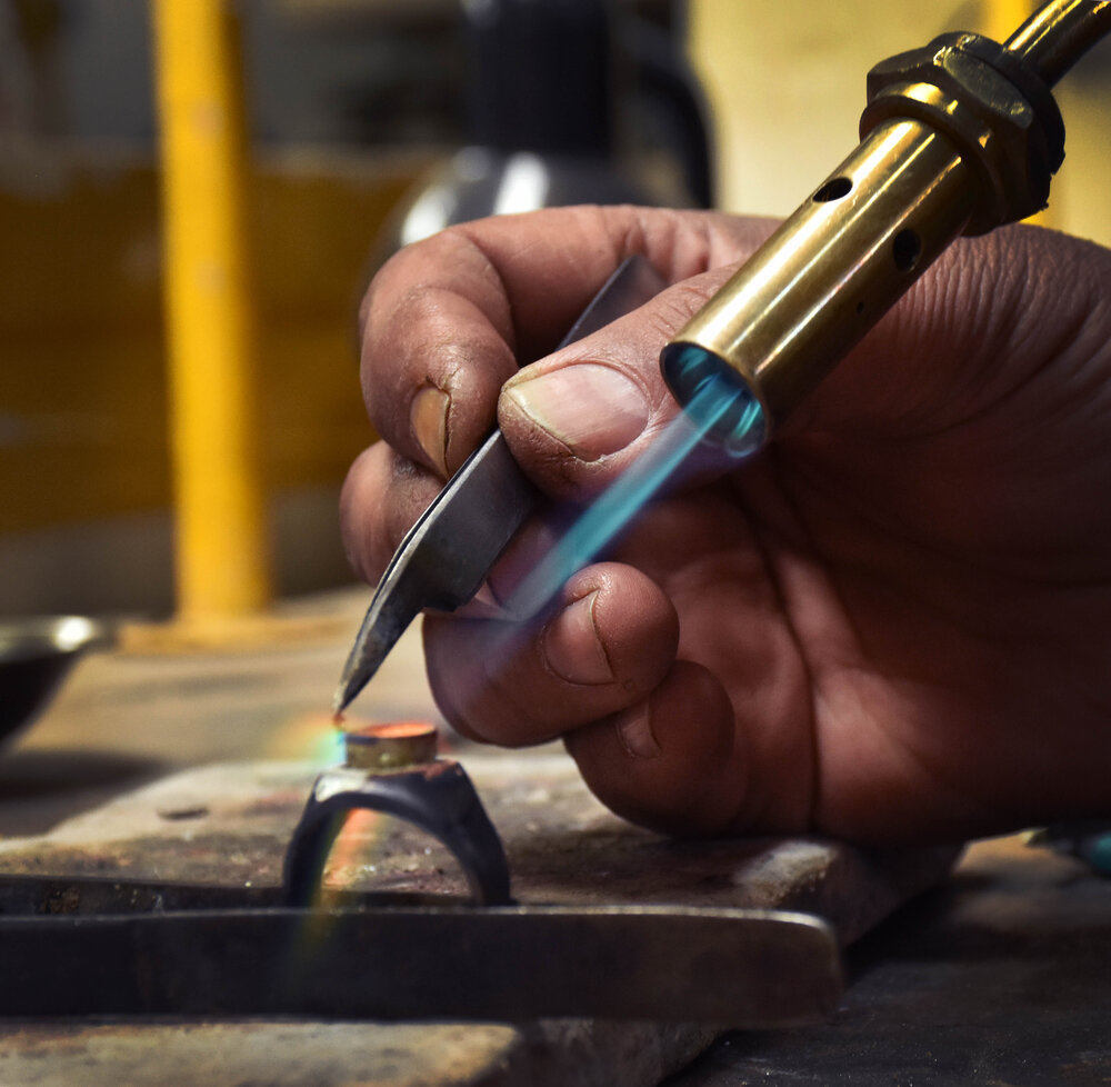 An artisan crafting jewellery with the torch. Photo: Turquoise Mountain.