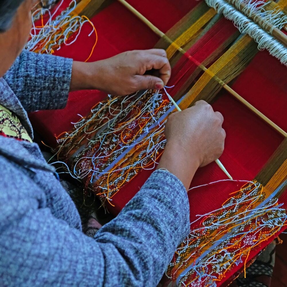 Artisan Hakha with her backstrap loom in Western Myanmar. Image: Turquoise Mountain.