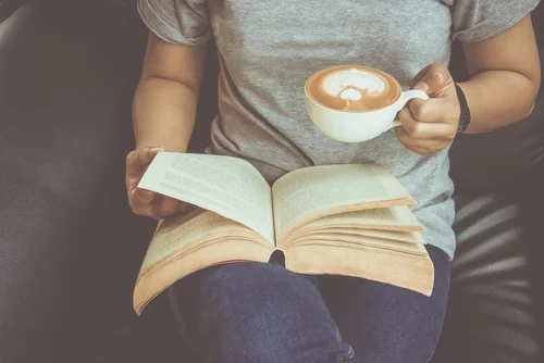 Reading a Book with a cup of Coffee