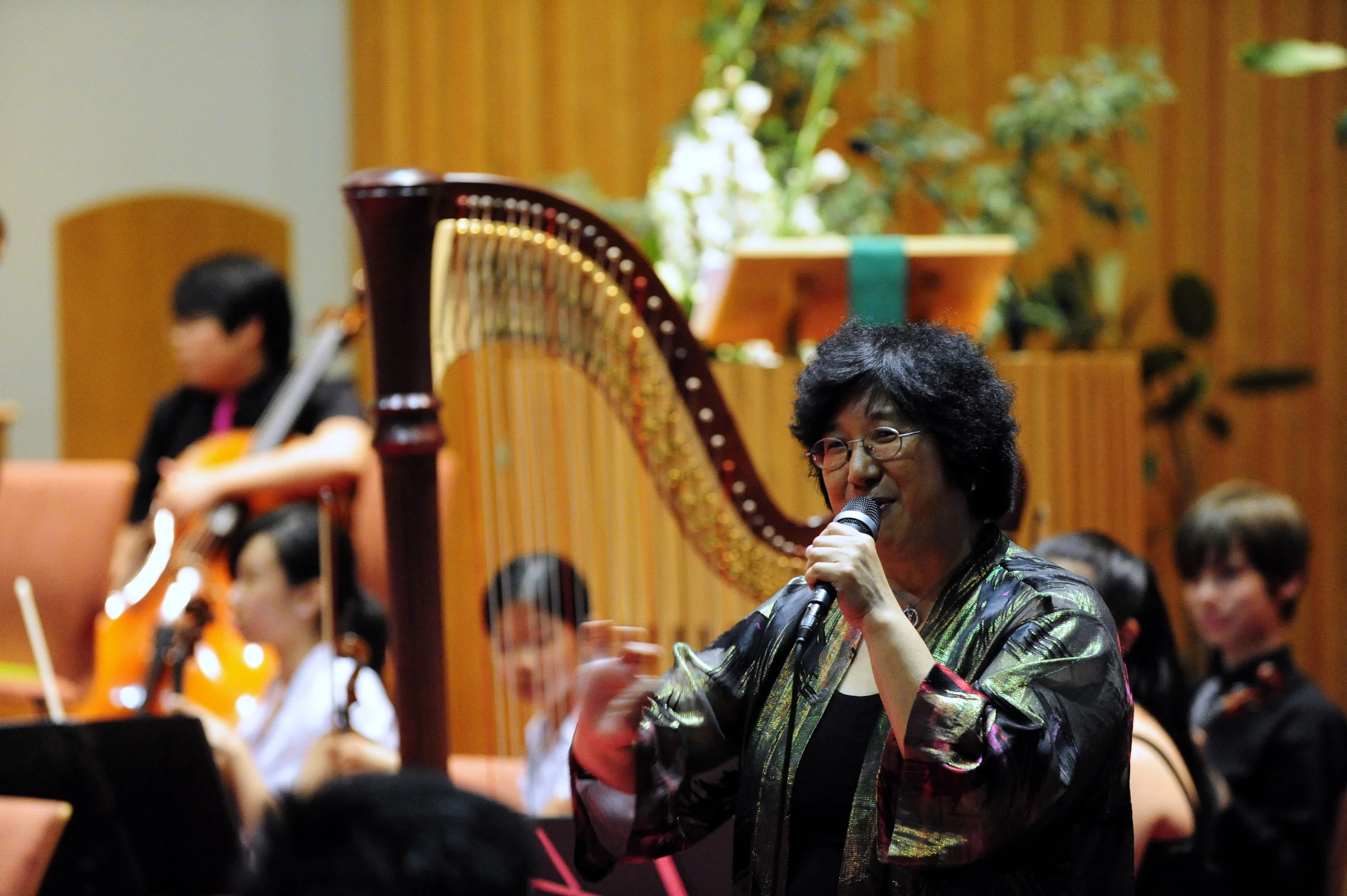 Ms. Lin makes announcements about the orchestra