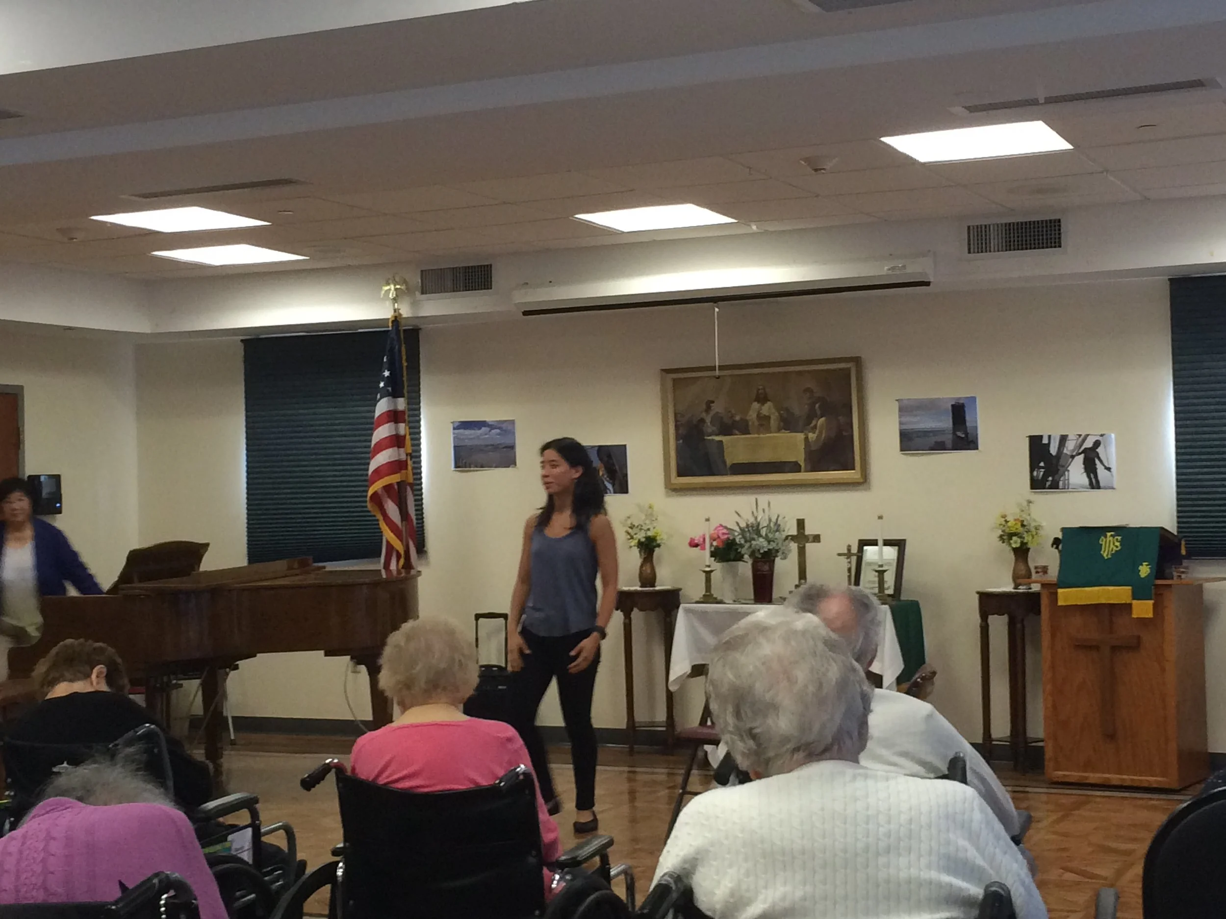 Program director Constance Kaita introduces the young performers