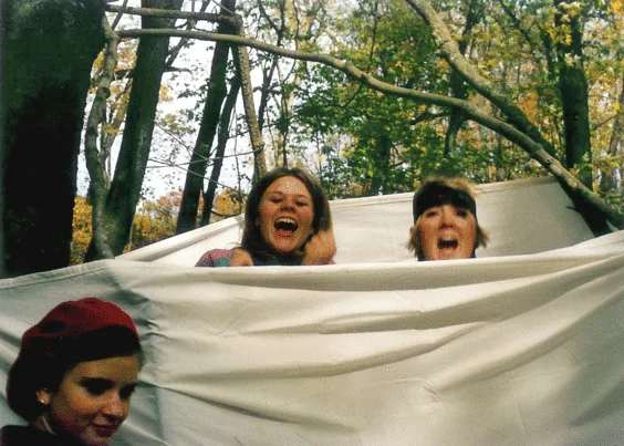 Stephanie and I with our friend Emily. We're in highschool on an art club field trip, and we're jumping around in a handmade teepee in the woods.