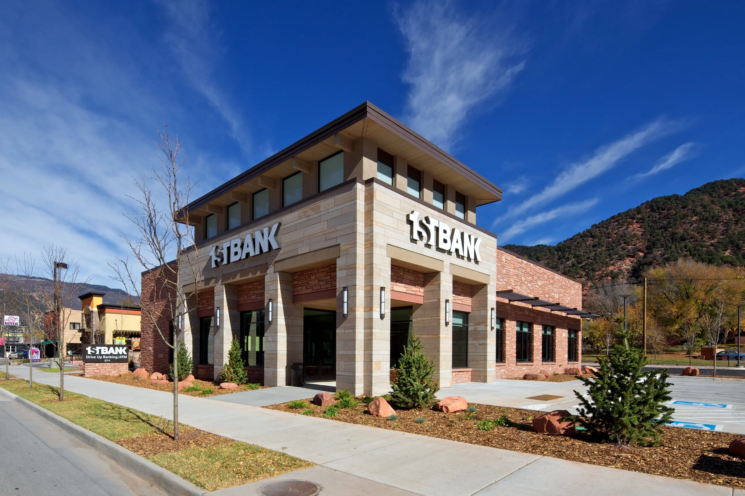 Stone detailing and a double-height street profile project the bank's respectability and complement the street's transition from suburban strip to urban walkability