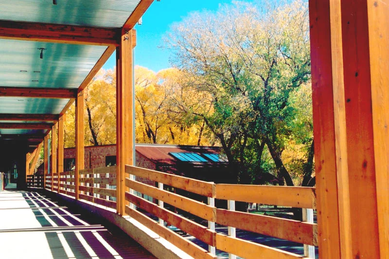 A rear walkway along the river provides access to offices and apartments