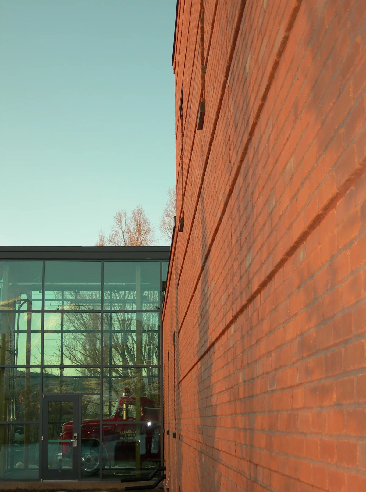 The historic fire truck's space projects out from the west facade